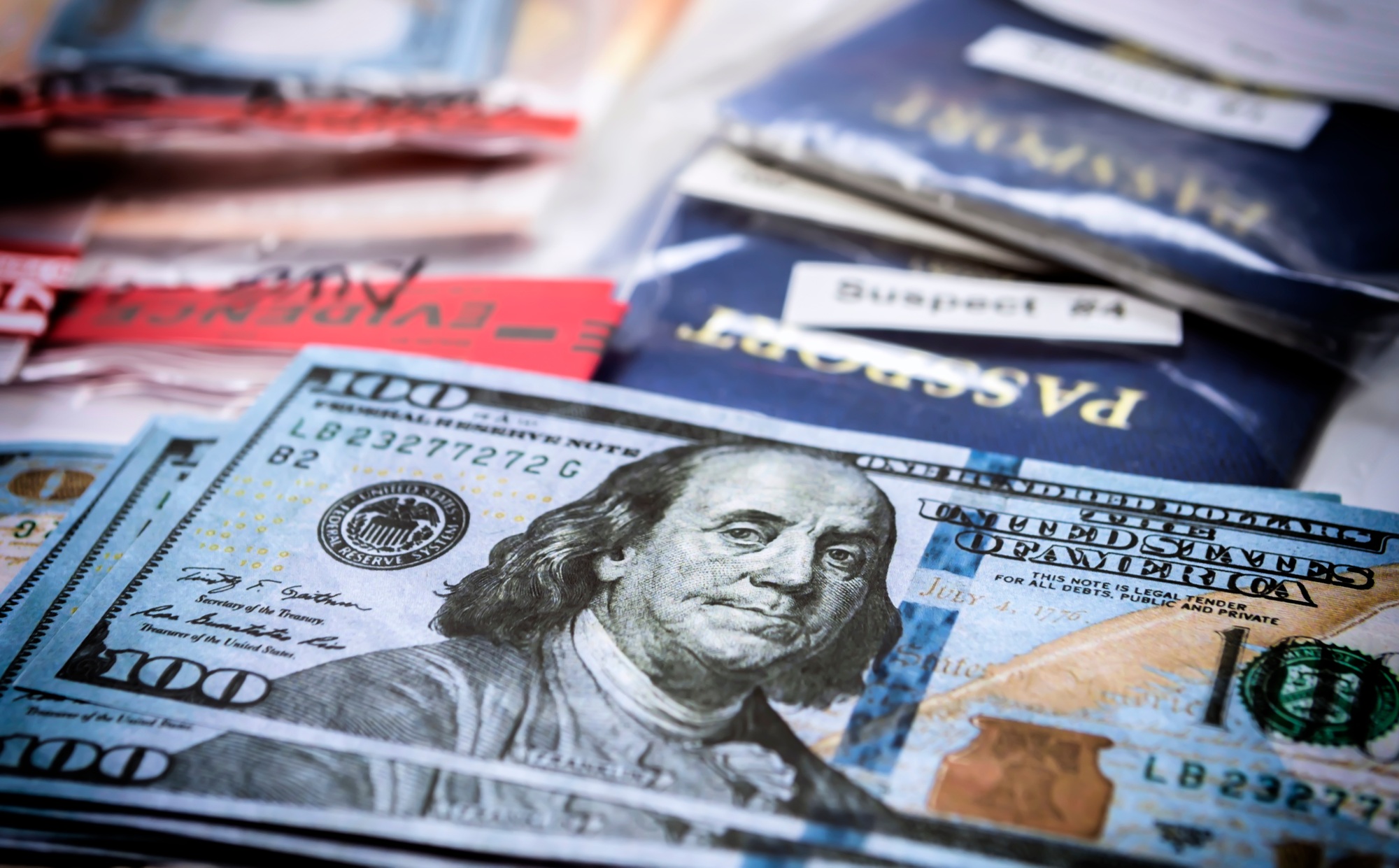 Some dollar bills on top of a passport, conceptual image
