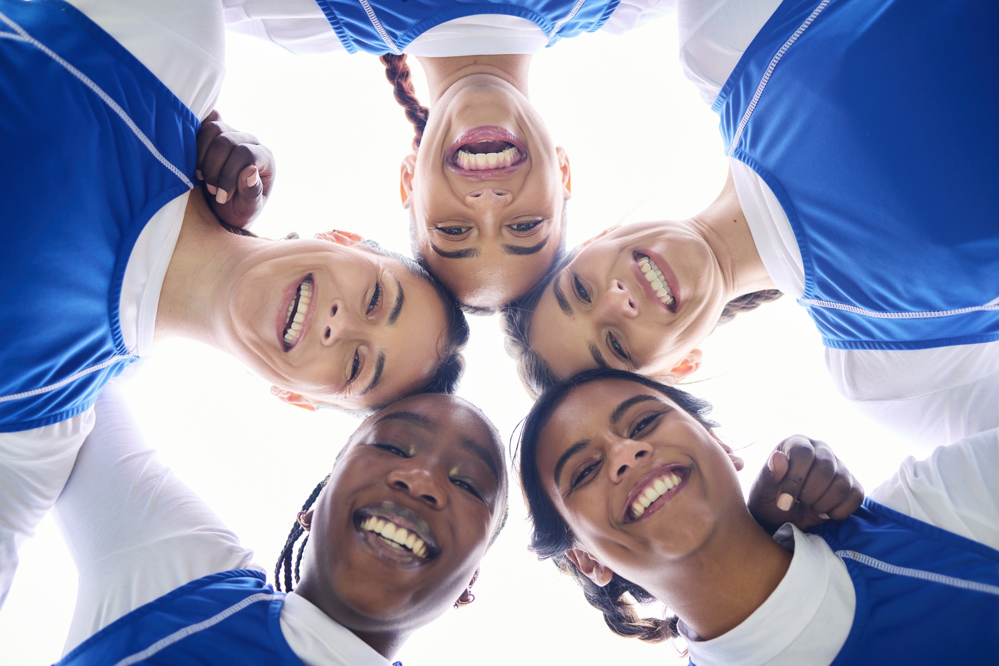 Sports women, circle and low angle for teamwork, motivation and portrait with support for training.