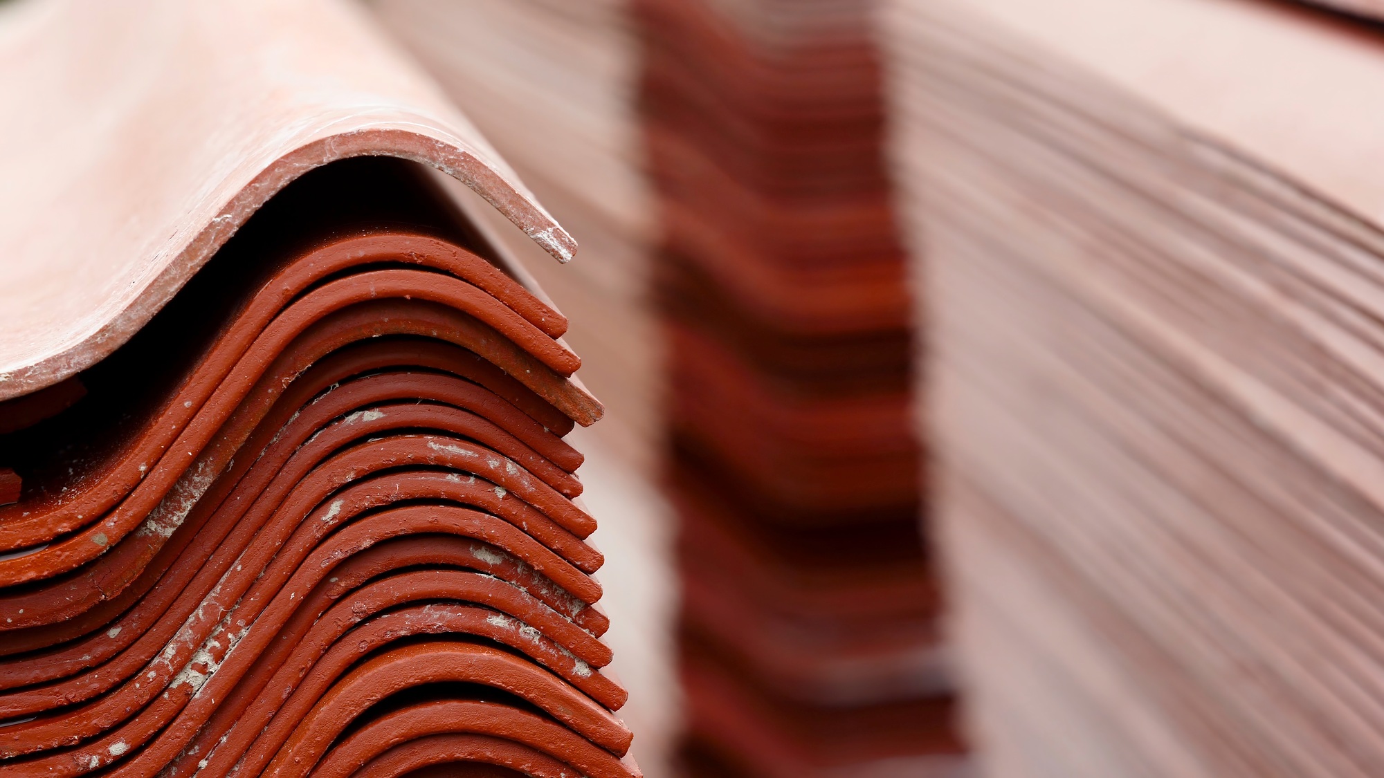 Stack red roof tiles, raw material for industrial of construction. Stock footage. Warehouse with red