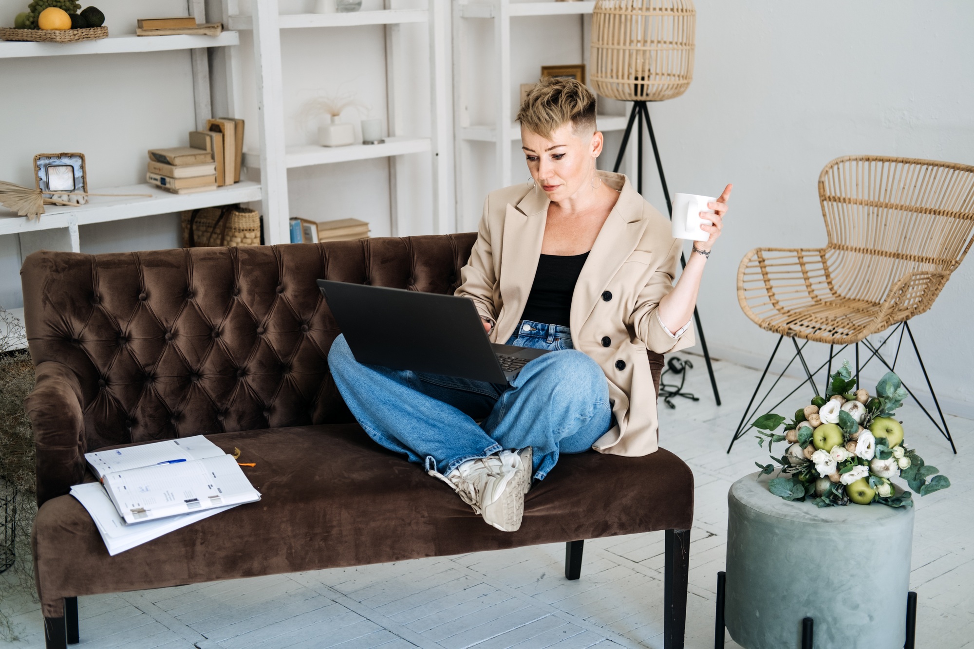 Start Own Business. Young trendy woman planning new project with papers and laptop in home office
