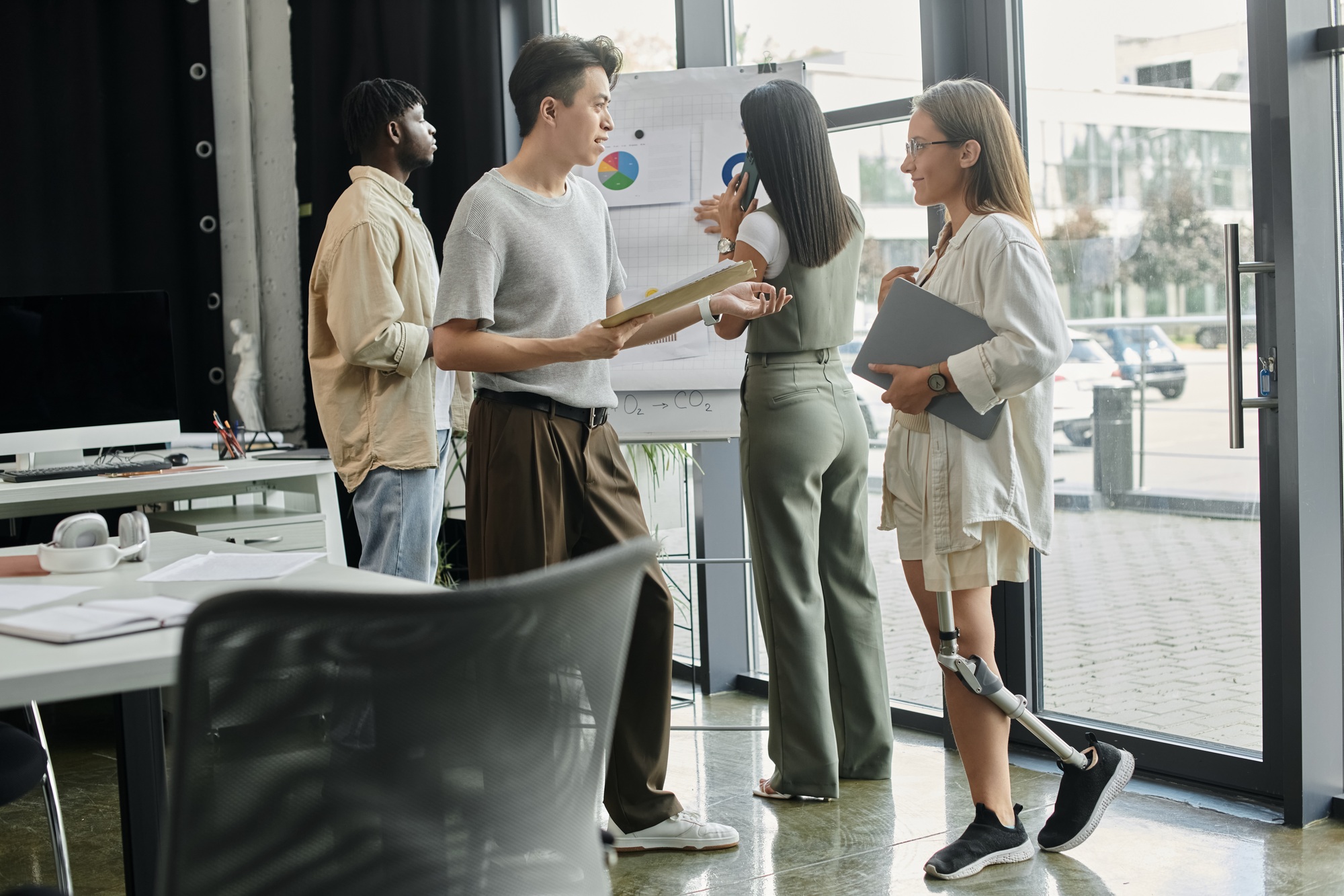 Startup Team Discusses Strategy in Modern Office