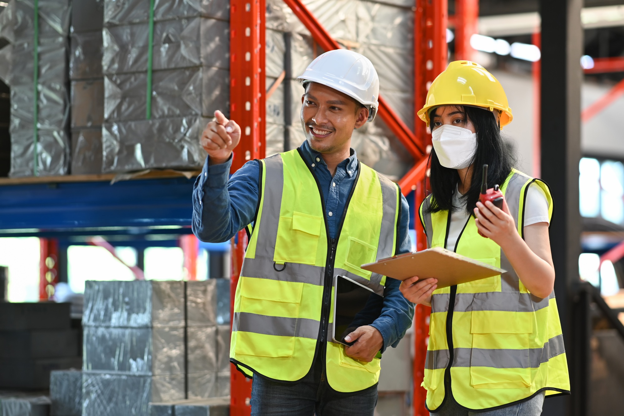 Storehouse workers are checking stock and inventory in retail warehouse.