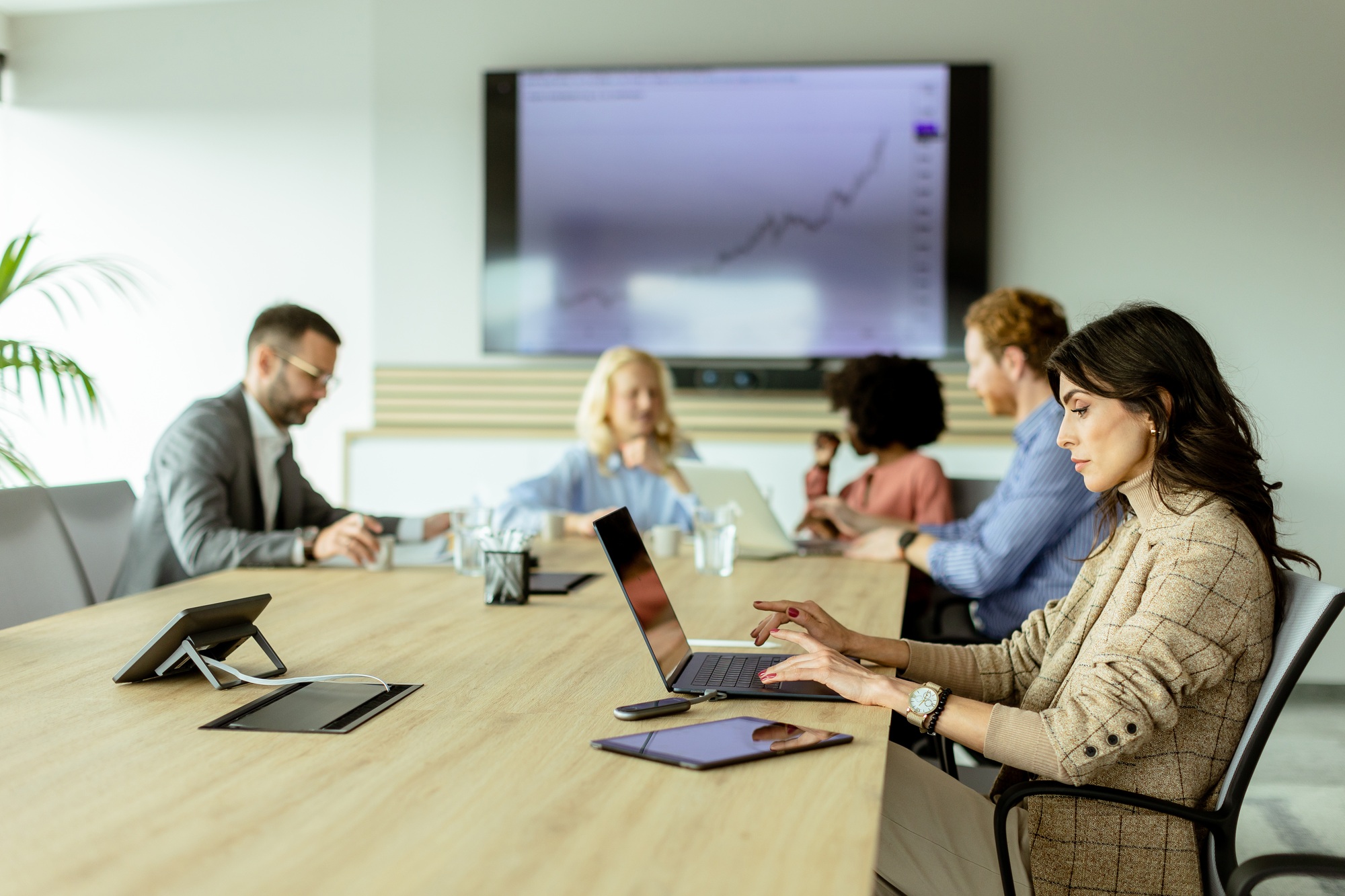 Strategic team meeting at a bright office space discussing growth metrics