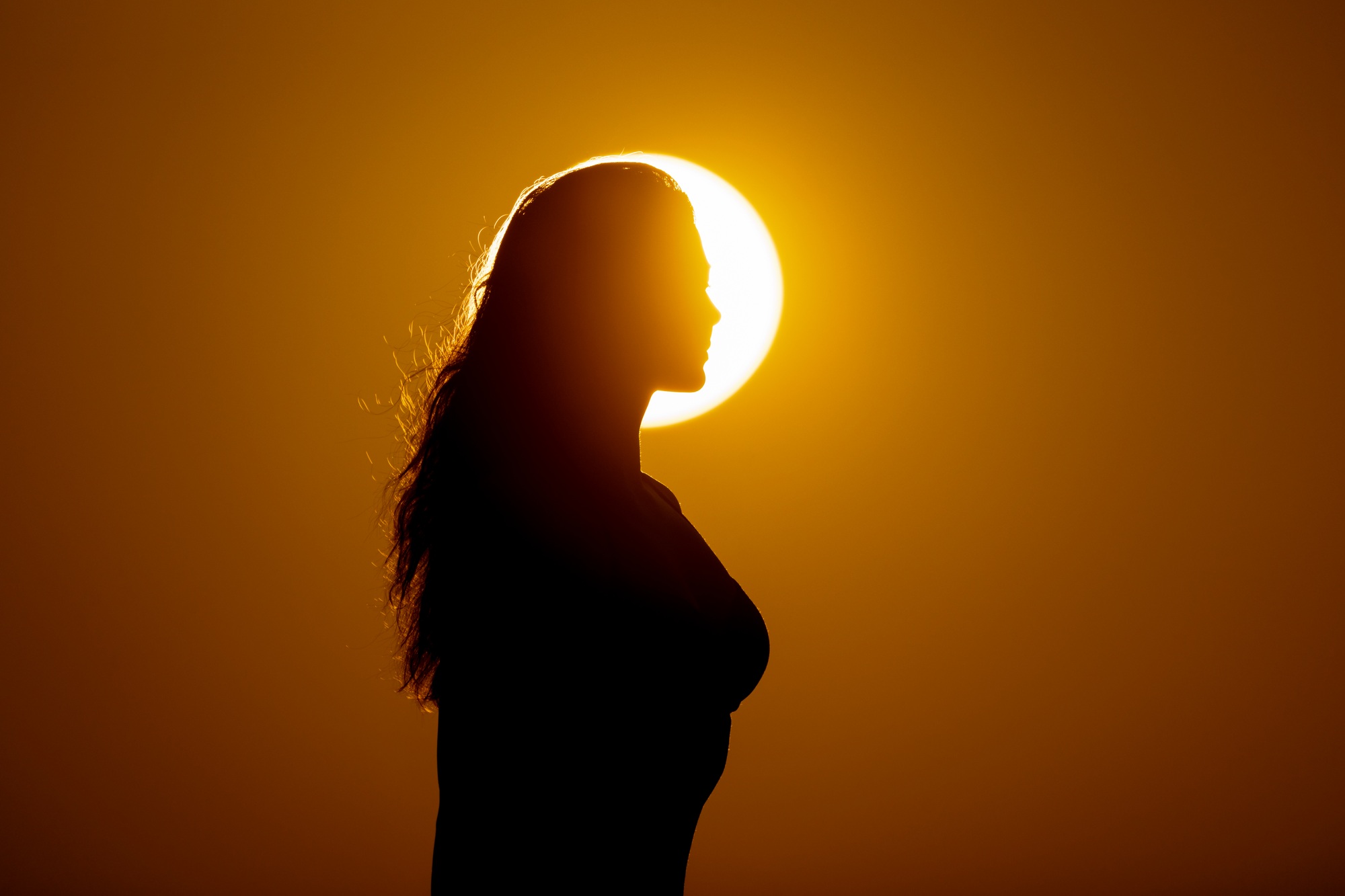 Strong woman, winning, success , and life goals concept. Young woman with arms flexed looking up to
