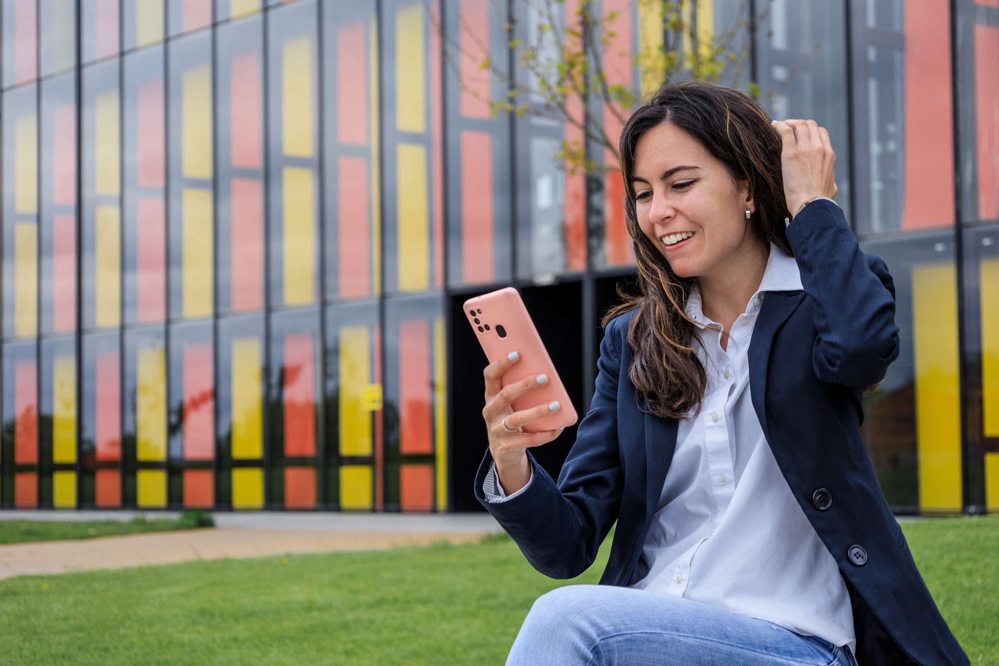 Successful business girl videocalling with smartphone and being promoted in modern park. Copy space.
