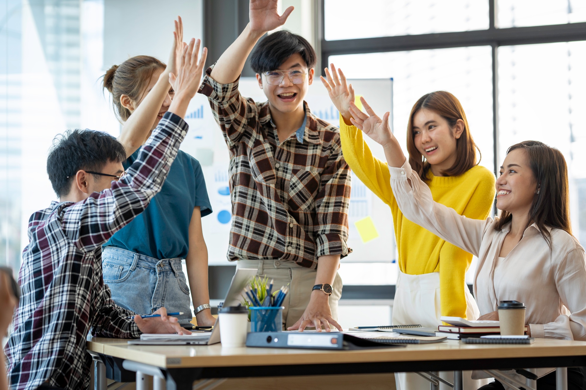 Successful entrepreneurs and Asian business people achieve goals