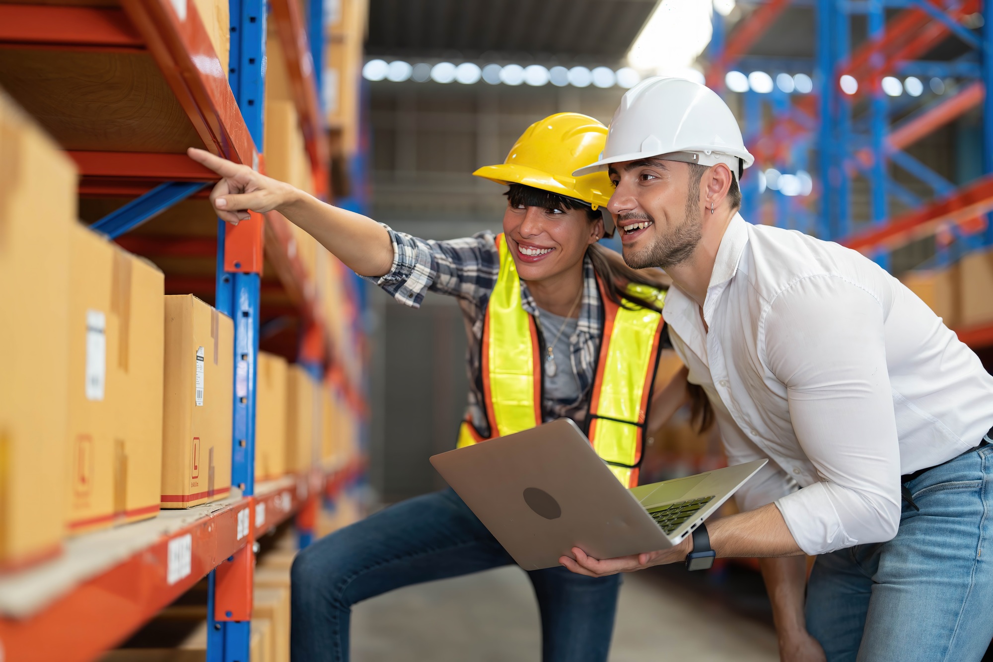 Supervisor and manager hold laptop computer visit warehouse annual audit inventory stock check