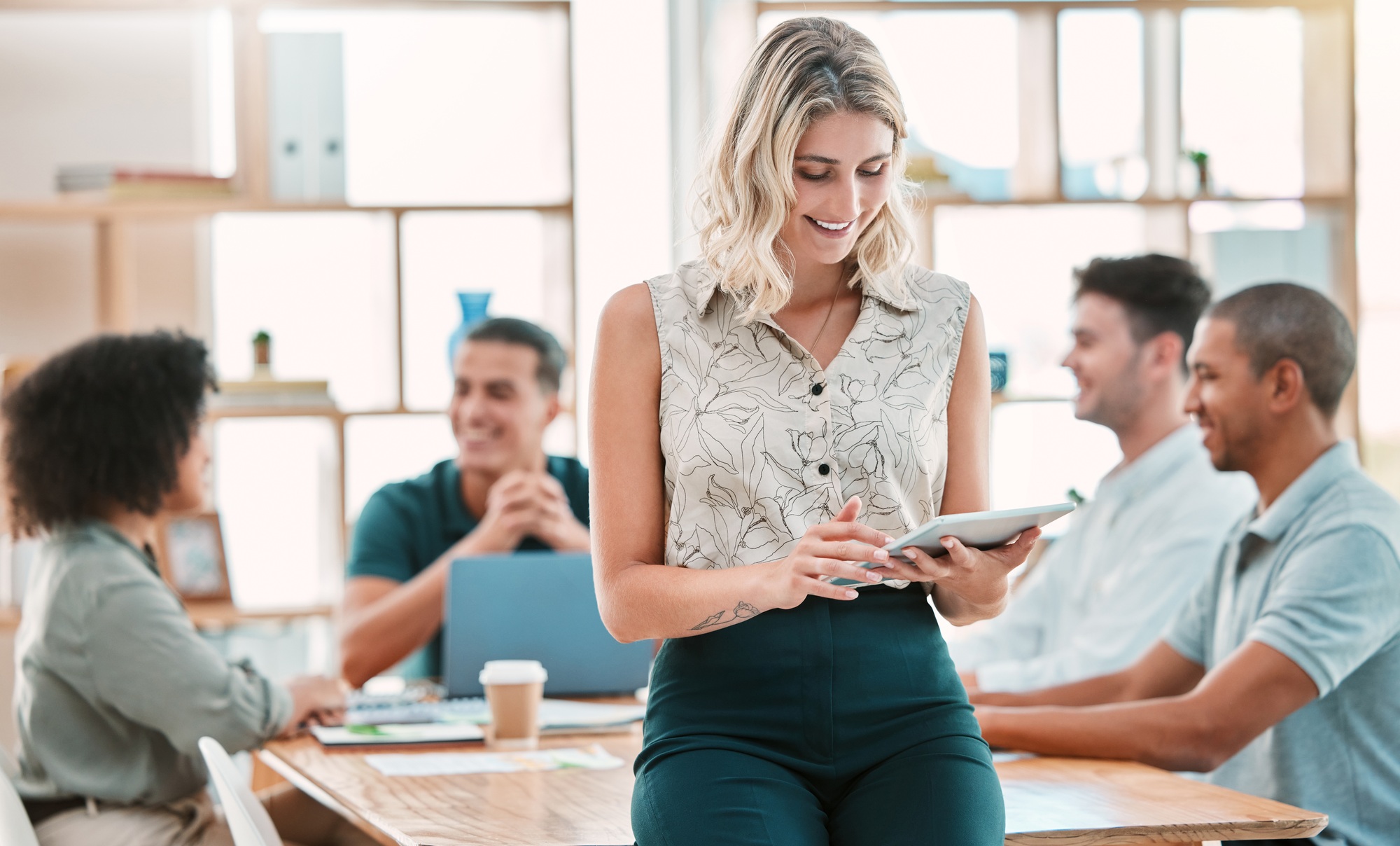 Tablet, leadership and meeting with a business woman in the boardroom with her team for training or