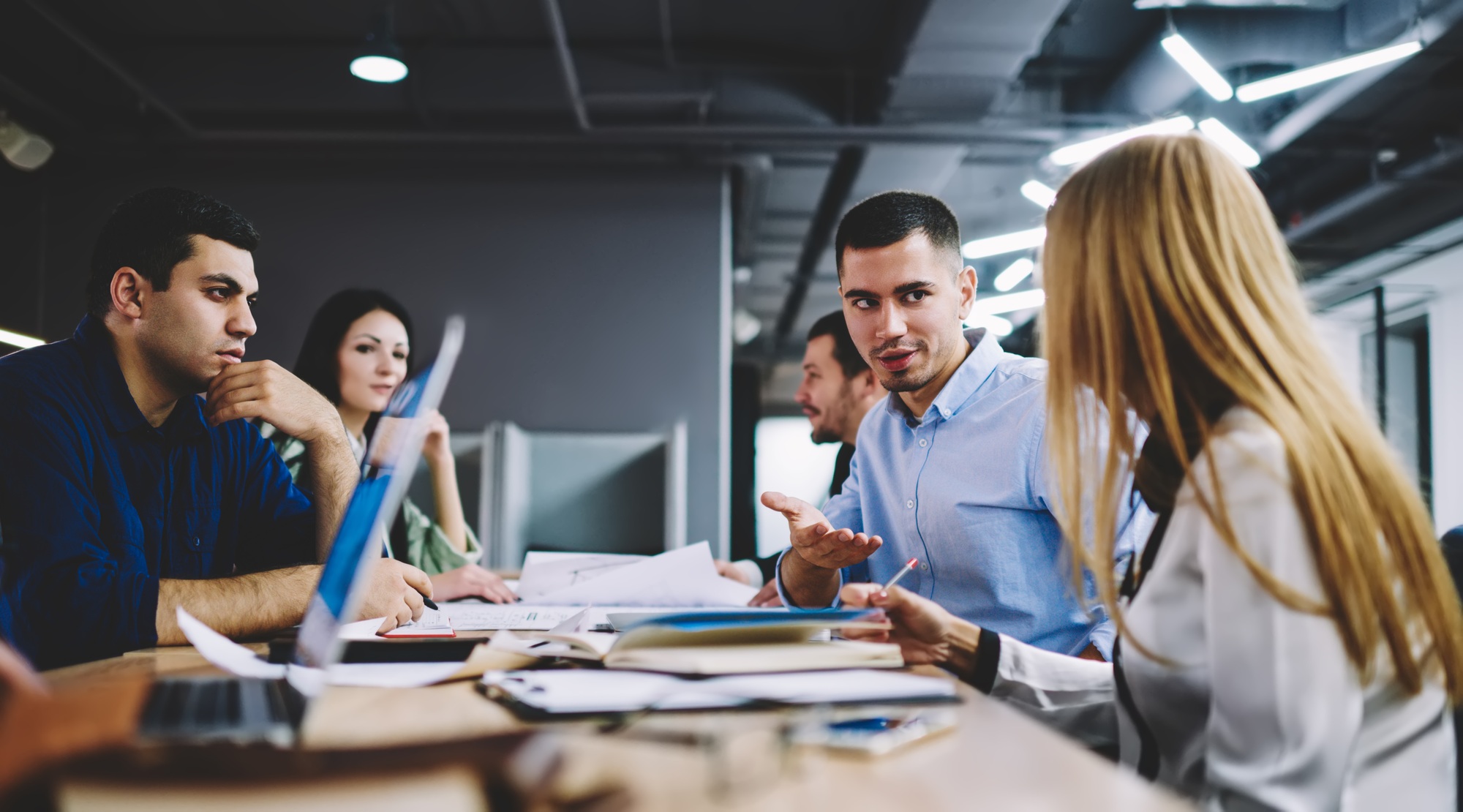 Talented employees talking about business strategy during working time in office interior