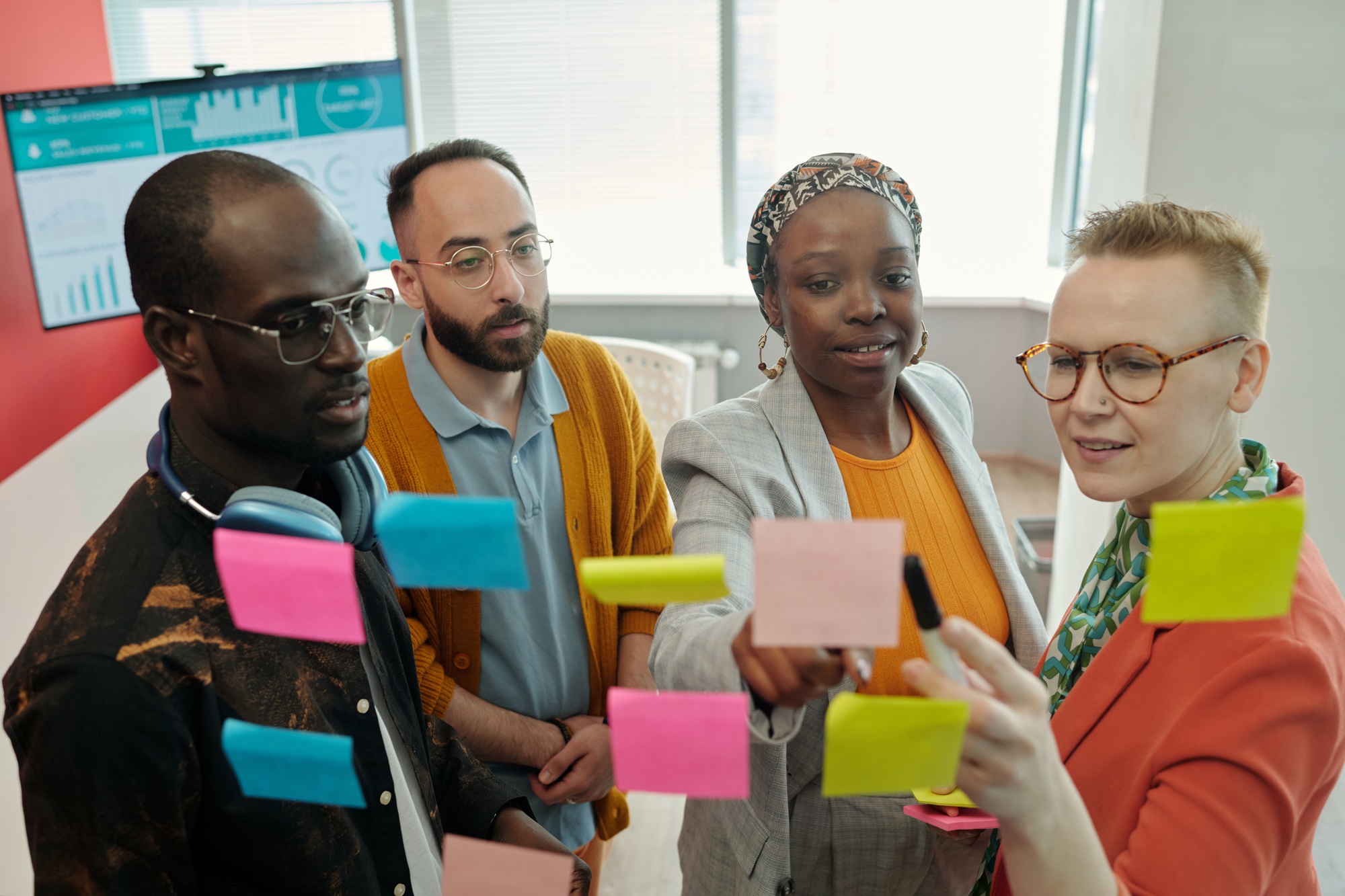 Team Discussing Strategies with Sticky Notes