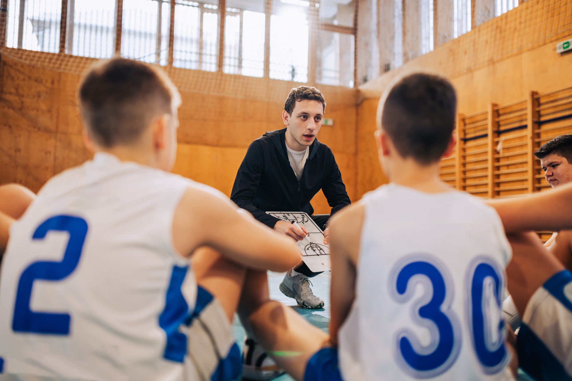 Team listens intently to coach's directions