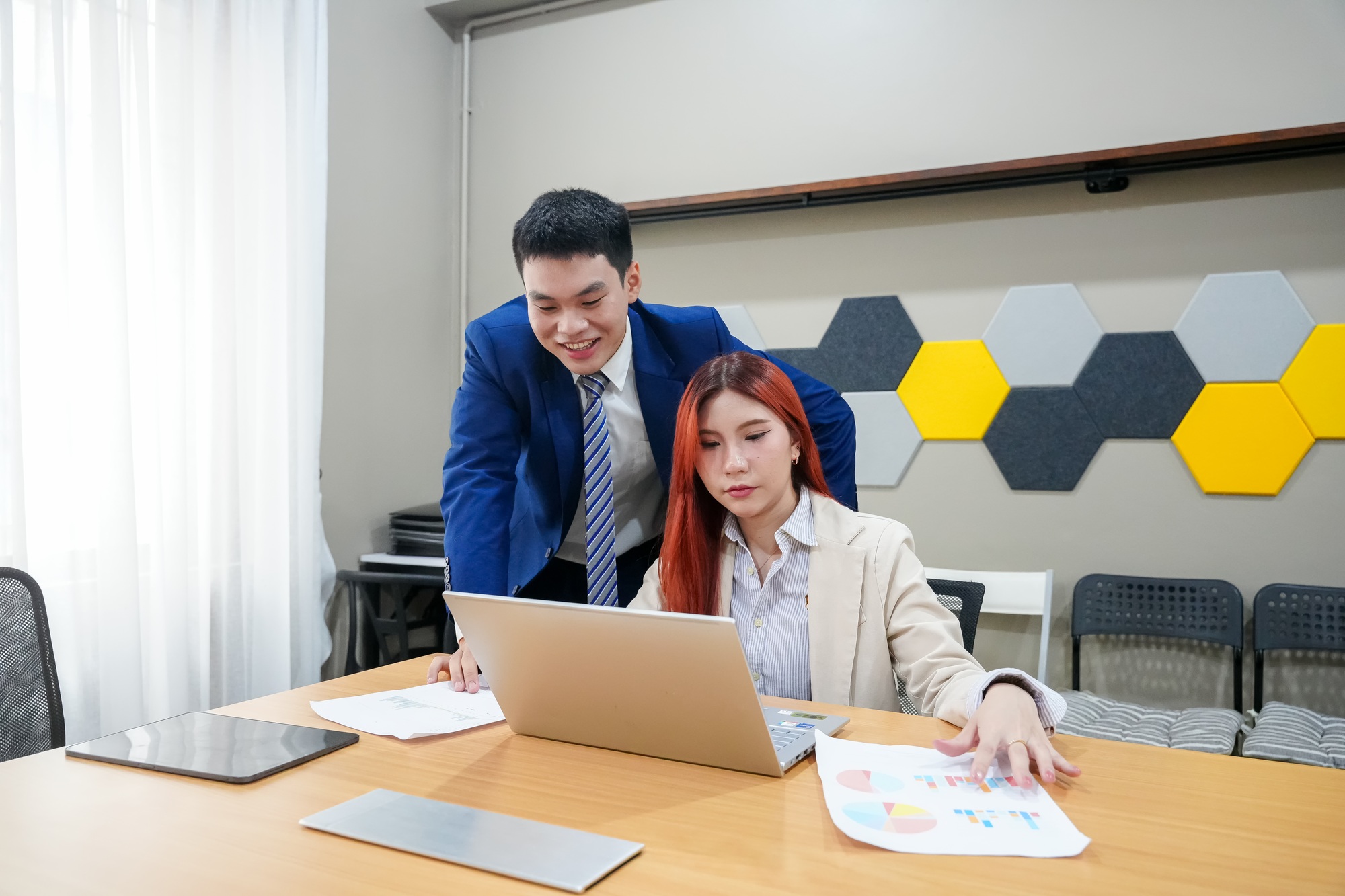 Team members collaborate on project review in modern office space
