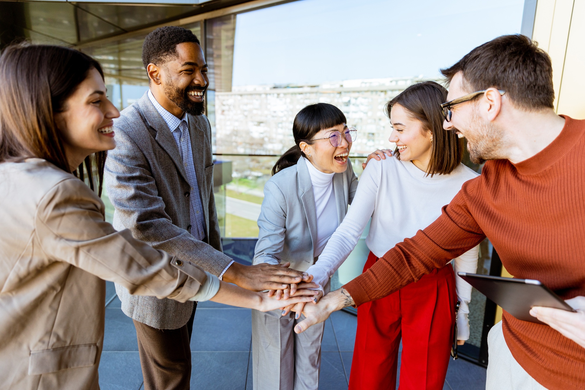 Team members engage in a joyful collaboration during a strategy meeting in a modern office setting