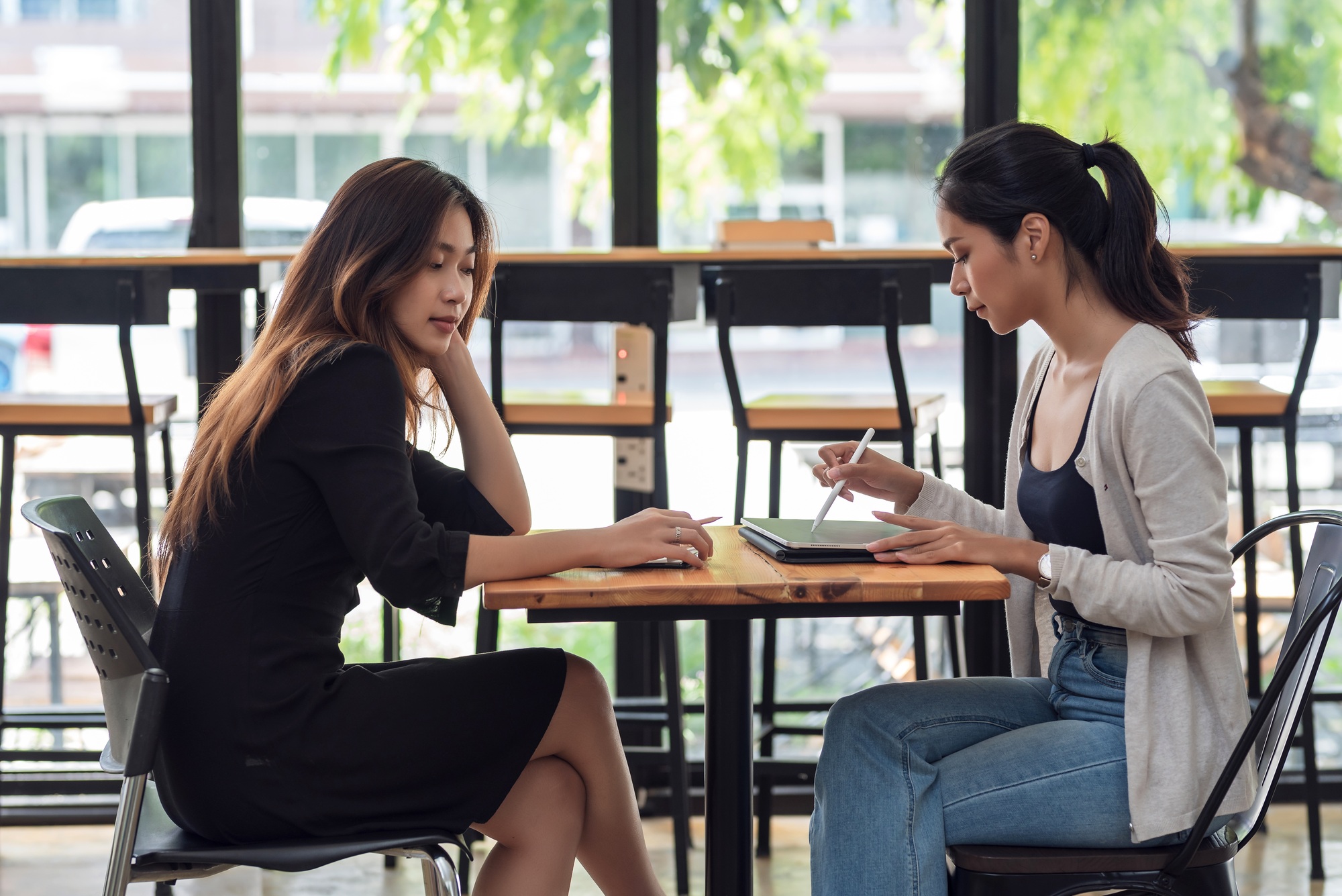 Team of young Asian businesswoman sitting at work meeting learning to work together brainstorm at th