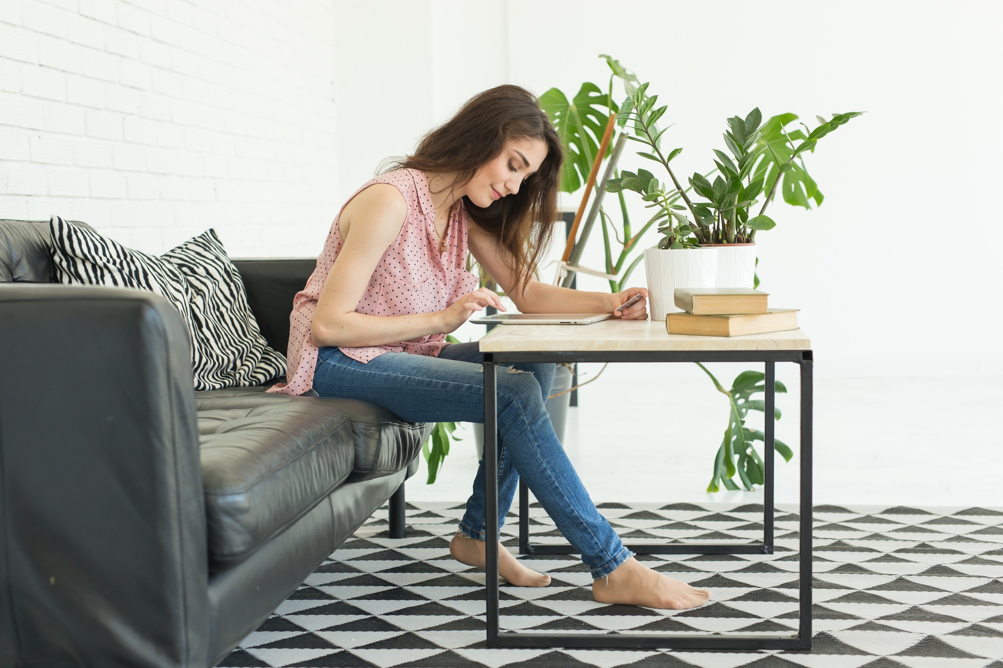 Technology, internet and people concept - young woman using tablet at home