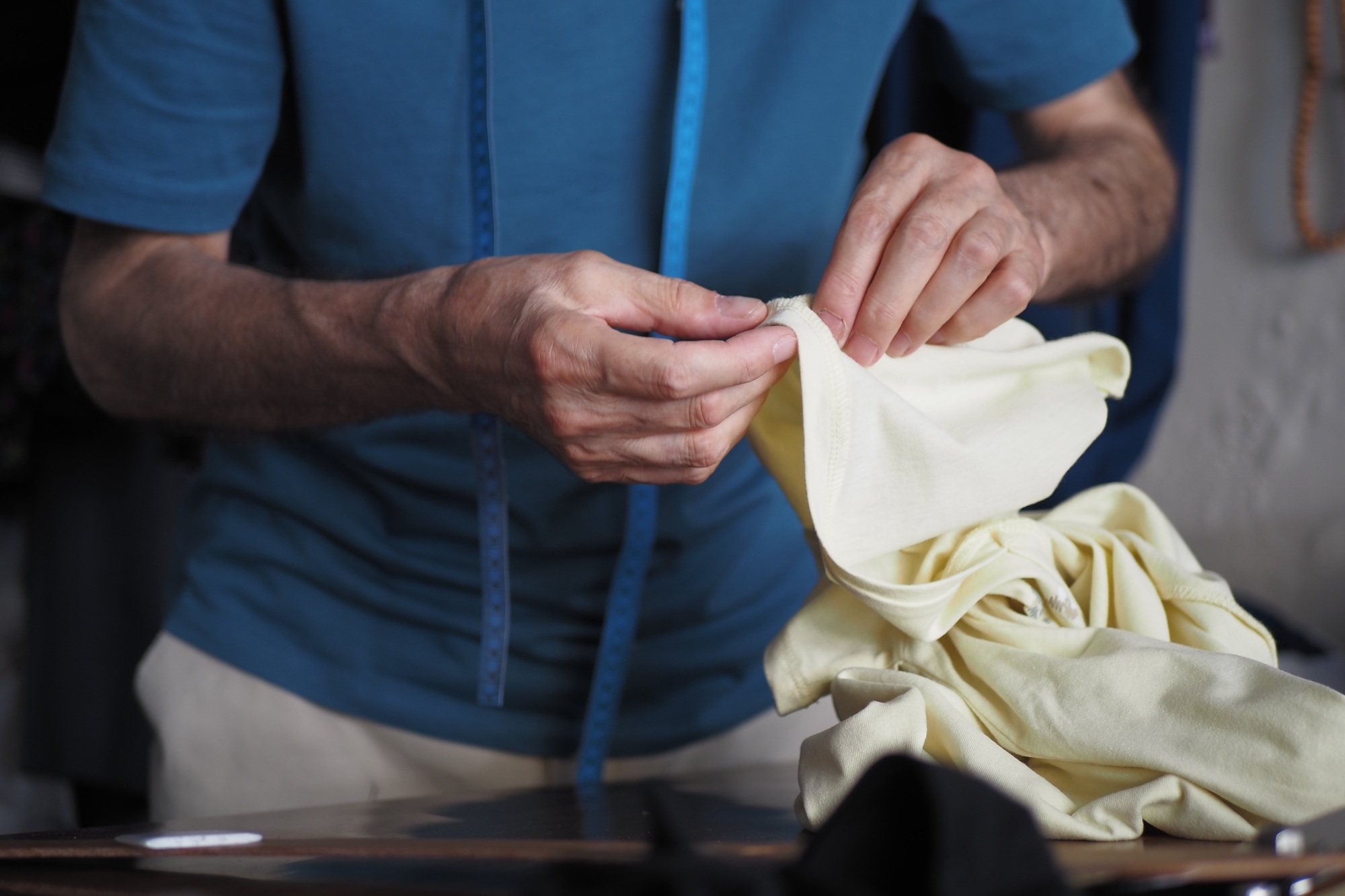 The Hands of a Highly Skilled Tailor are Carefully Sewing Fabric with Great Precision