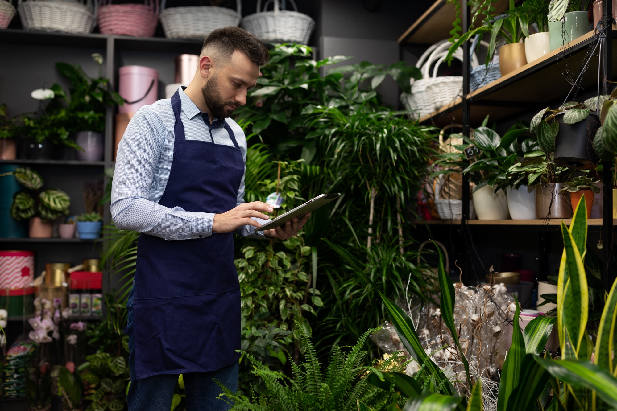 the owner of a potted plant shop doing inventory