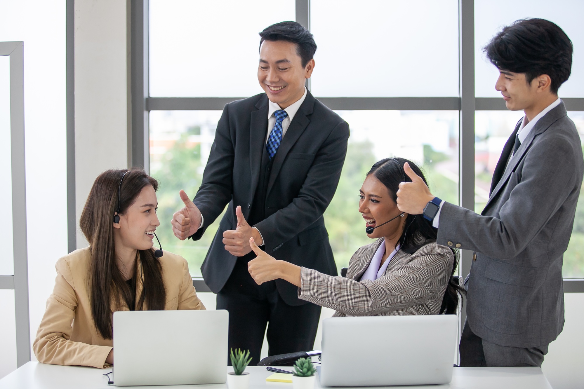 The supervisor compliments and encourage the employees in the office, business concept.