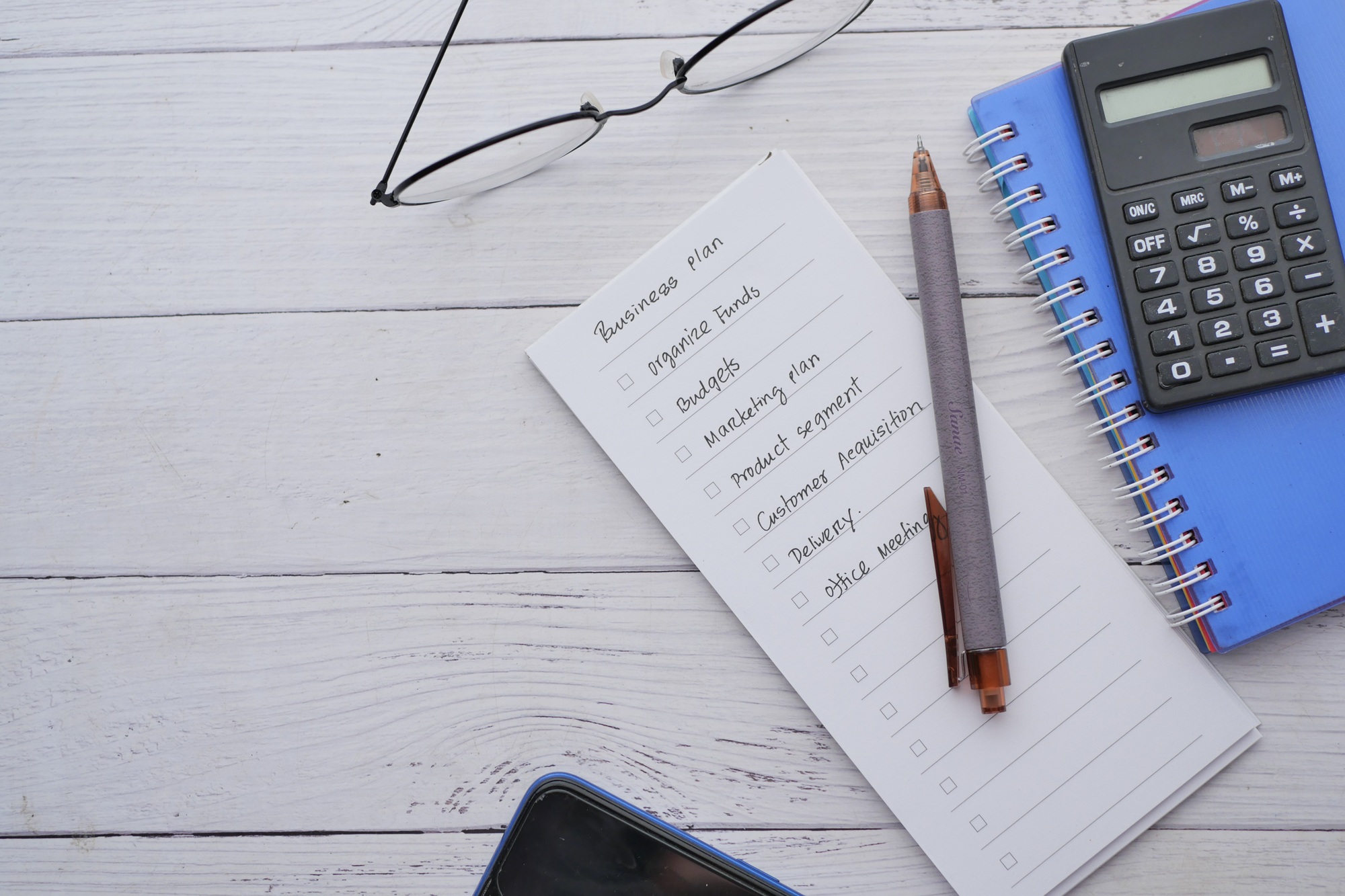 tick mark on planning goals on notepad