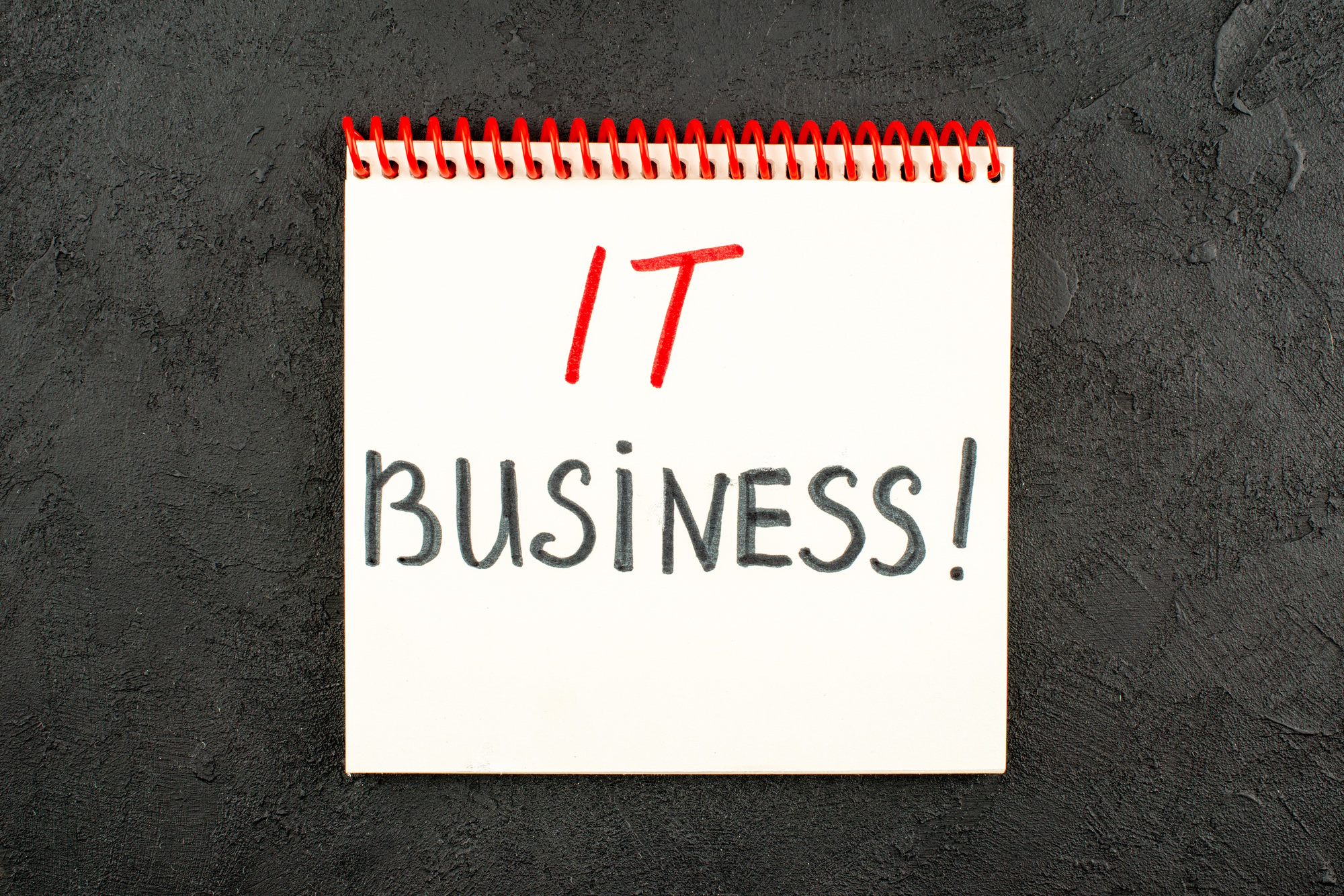 top view it business written on notebook on black background free space