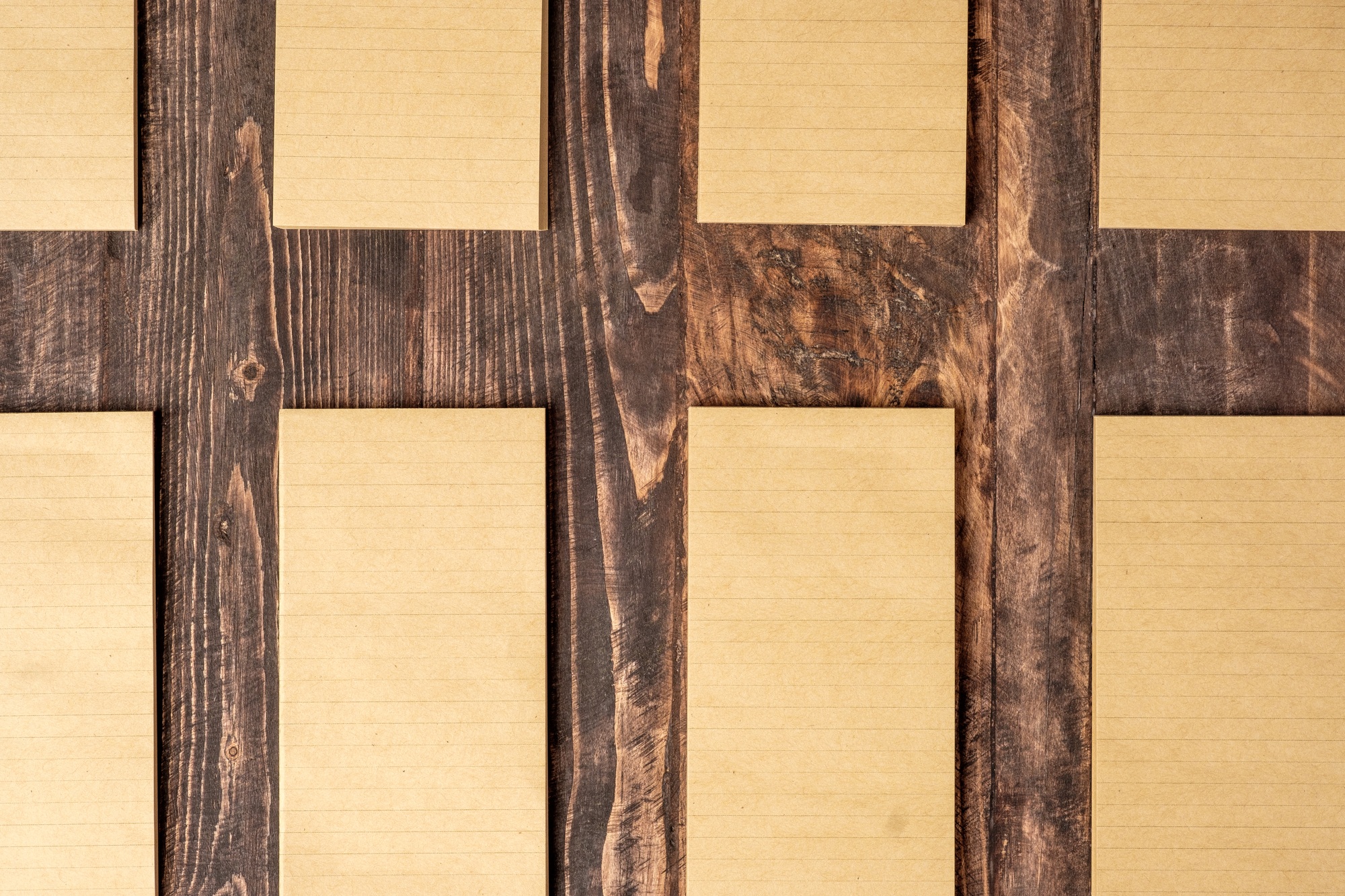 top view of group of yellow notepad align on wood table