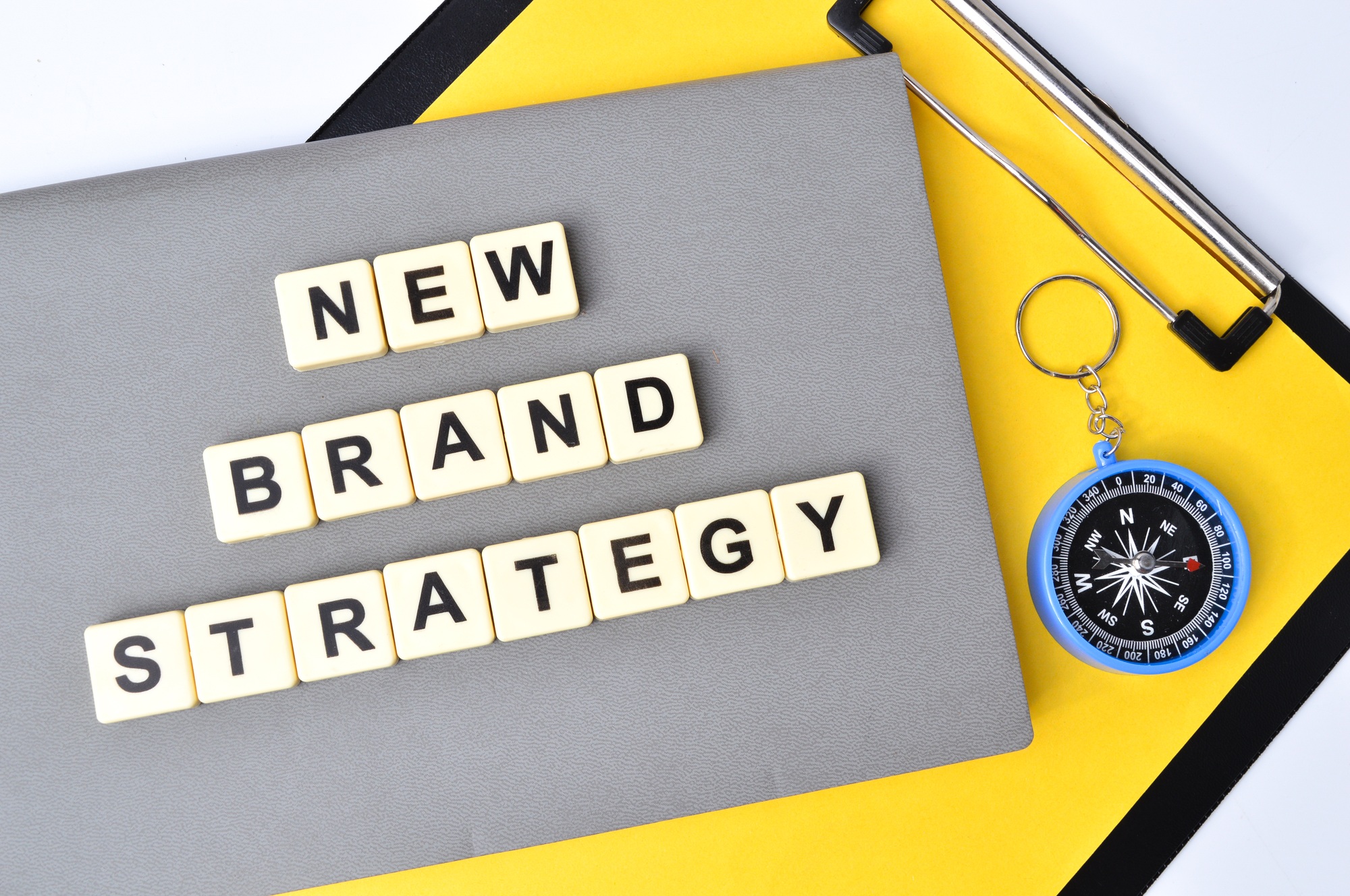 Top view of square letters with text NEW BRAND STRATEGY.