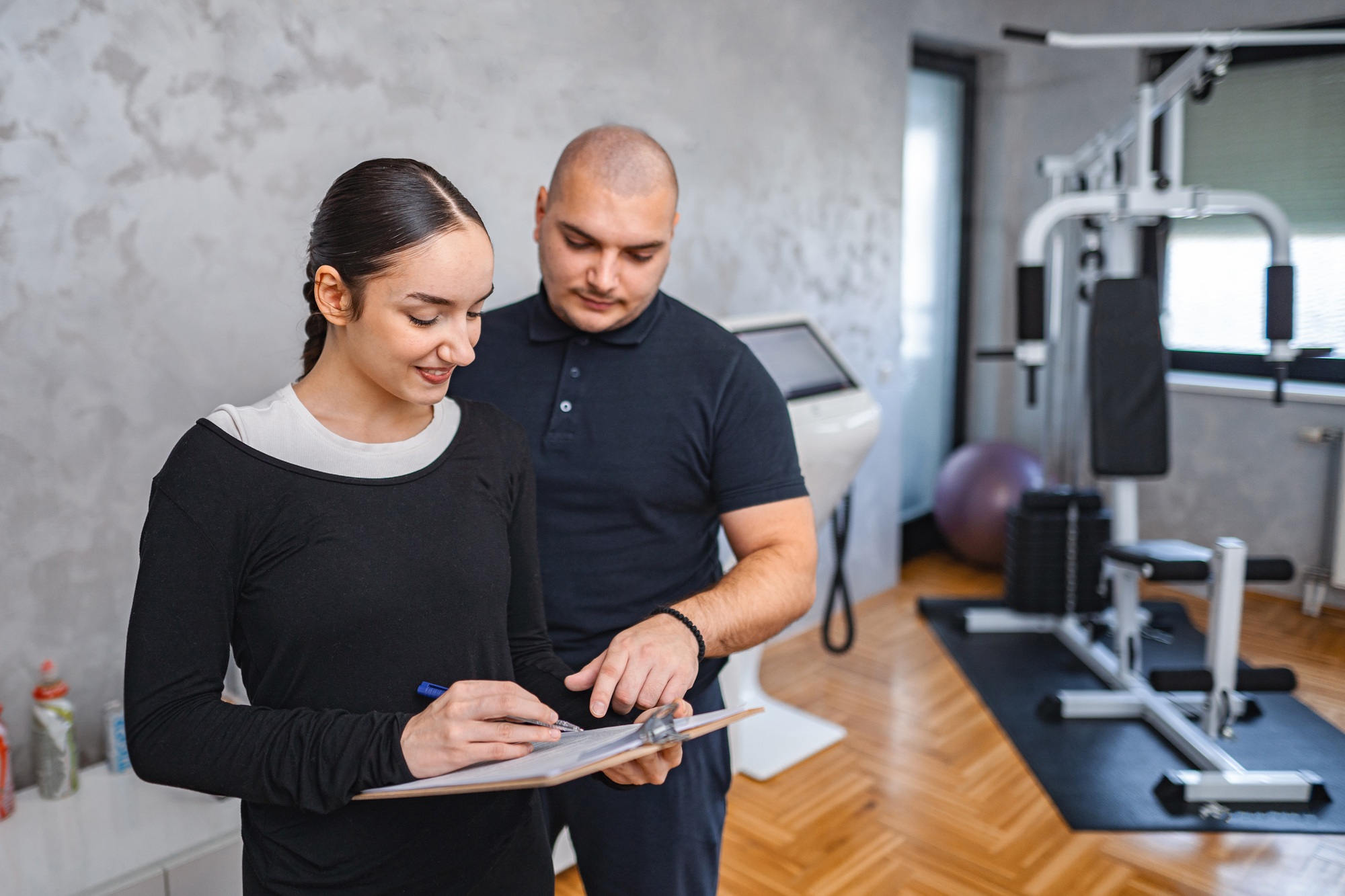 Trainer guiding a client on fitness goals during a session