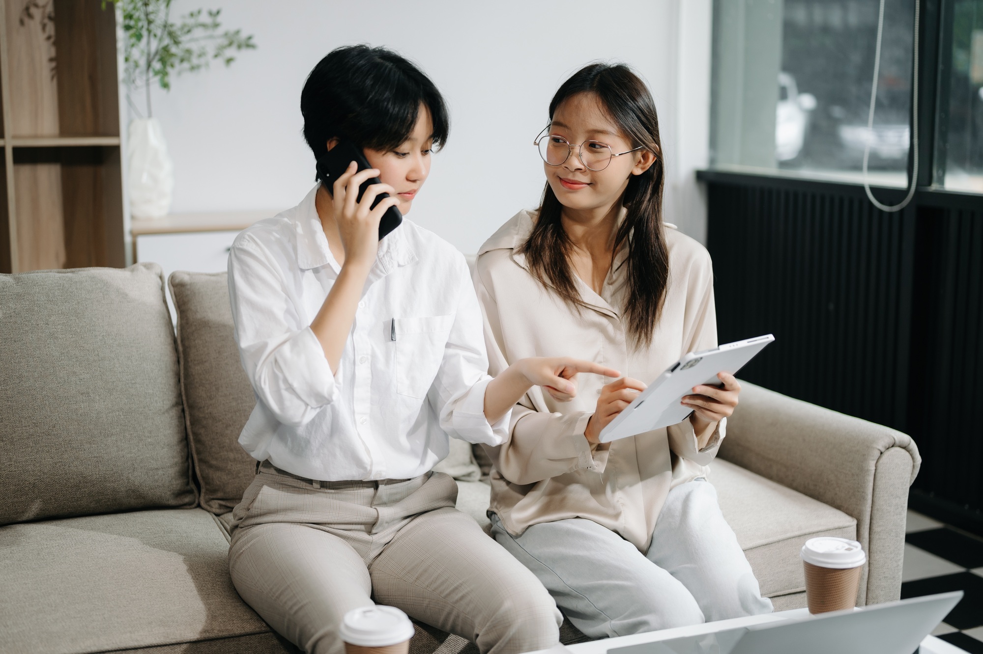 Two Asian businesswoman discuss investment project working and planning strategy