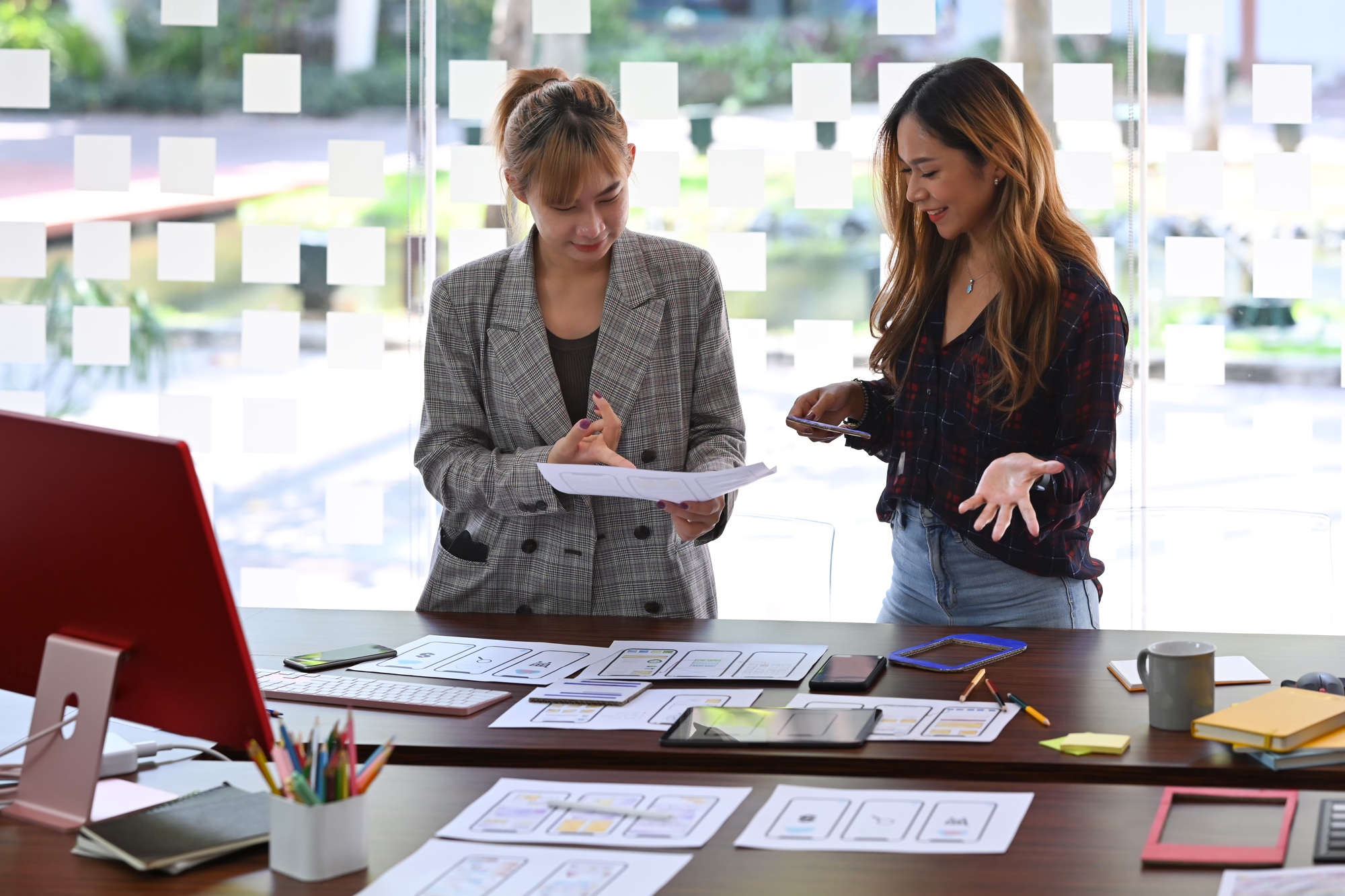 Two creative women are planning application and developing template layout, framework.