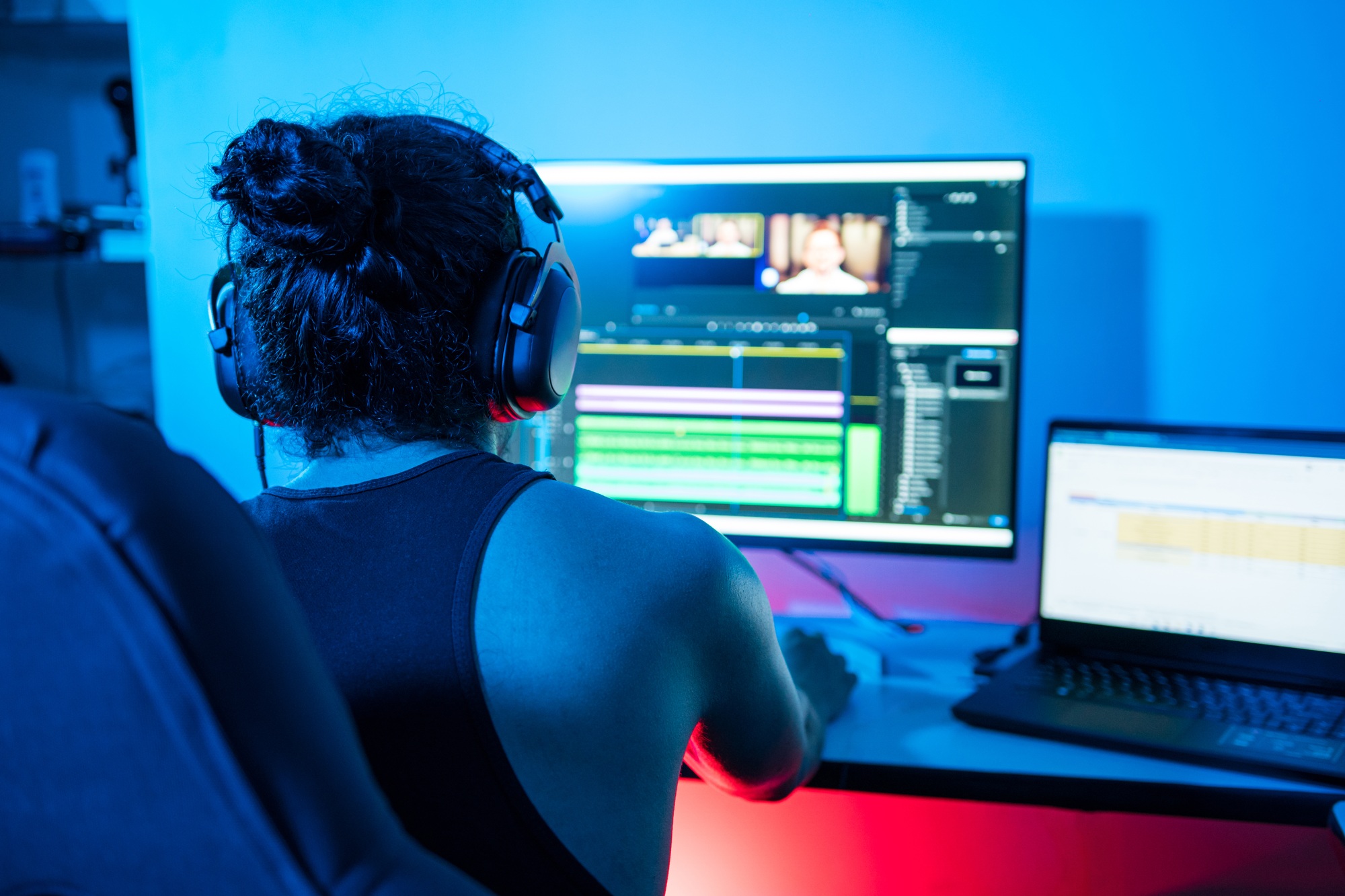 Video editor editing a commercial. Person working from home at night