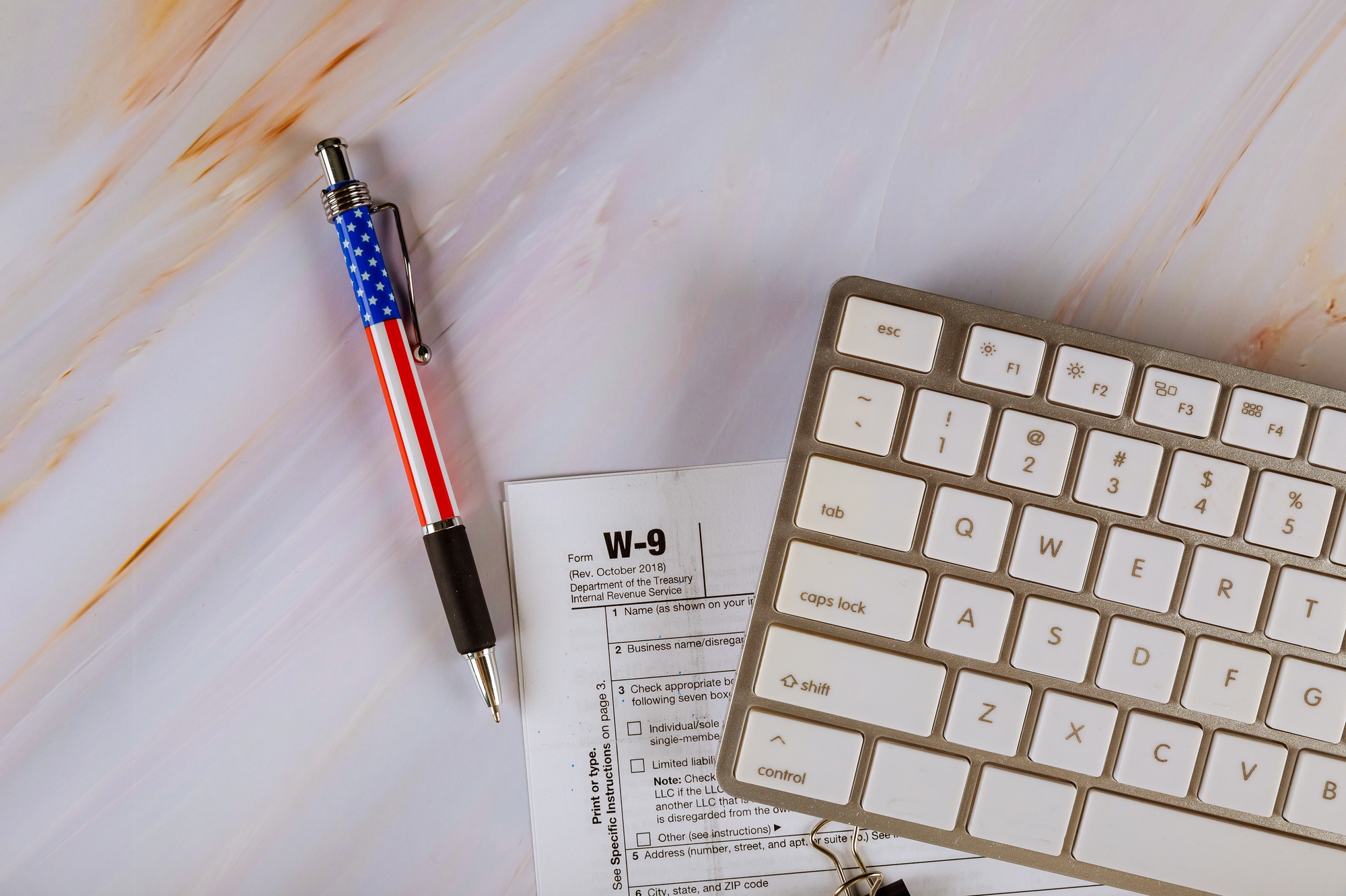 W-9 USA federal business finance tax form from the Internal Revenue Service with pen