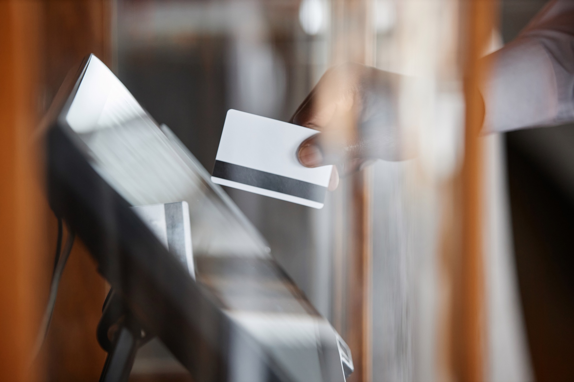 Waiter using computer in restaurant putting order in electronic POS system