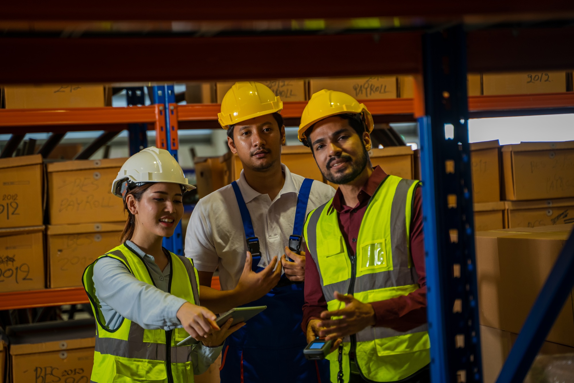 Warehouse employees uses digital tablet computer with Inventory checking software.