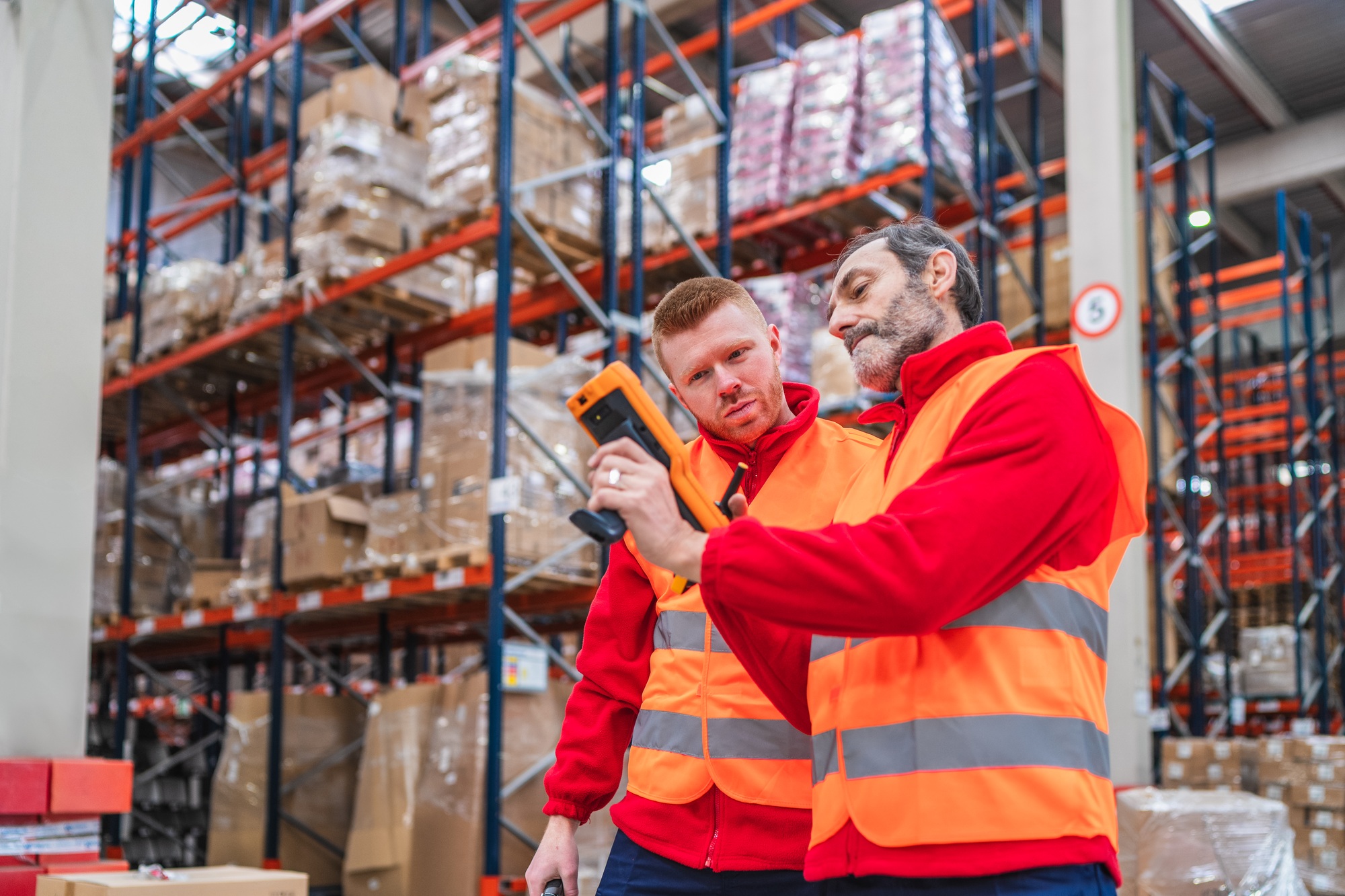 Warehouse workers using barcode scanner for inventory management