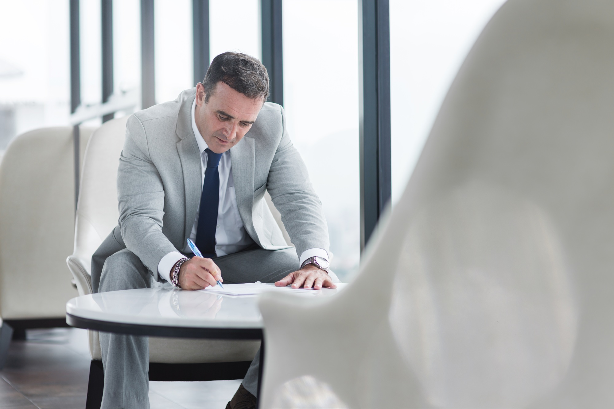 Weigh your options. Businessman sitting in his office. Copy space on the right side