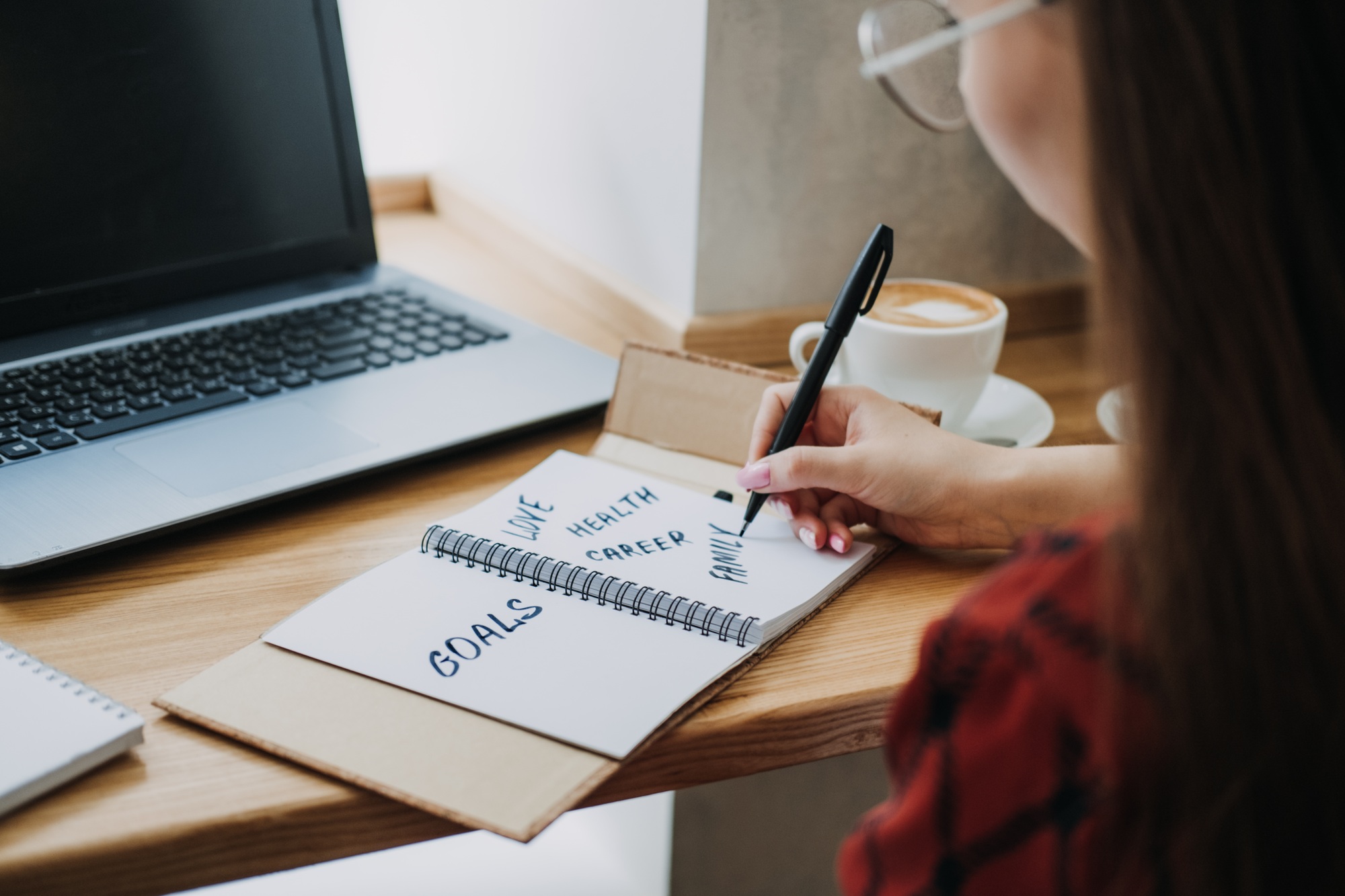 Main life goals, How to Set and Achieve Life Goals. Young woman girl writing in notebook life goals