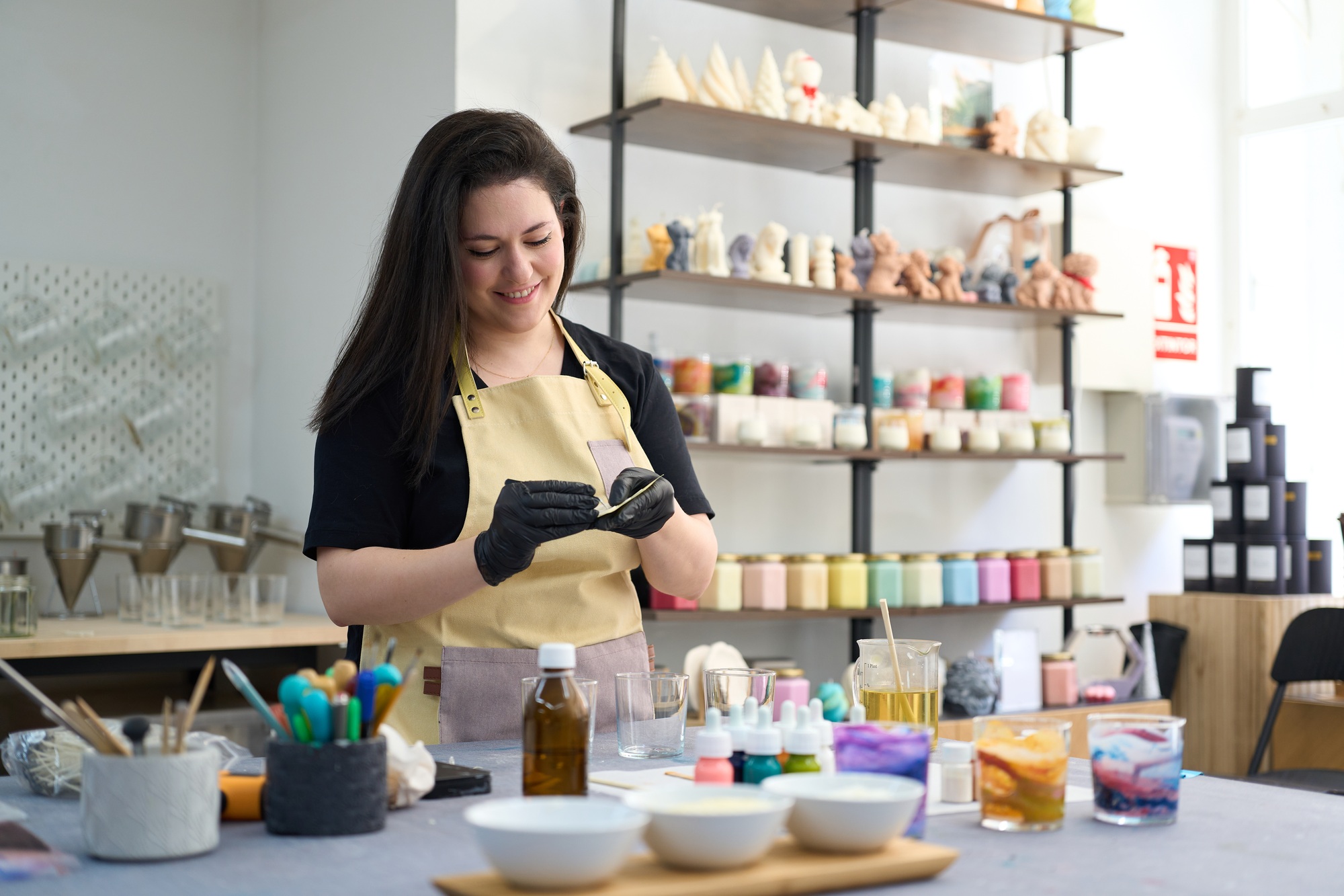 Woman making handmade candles in craft studio