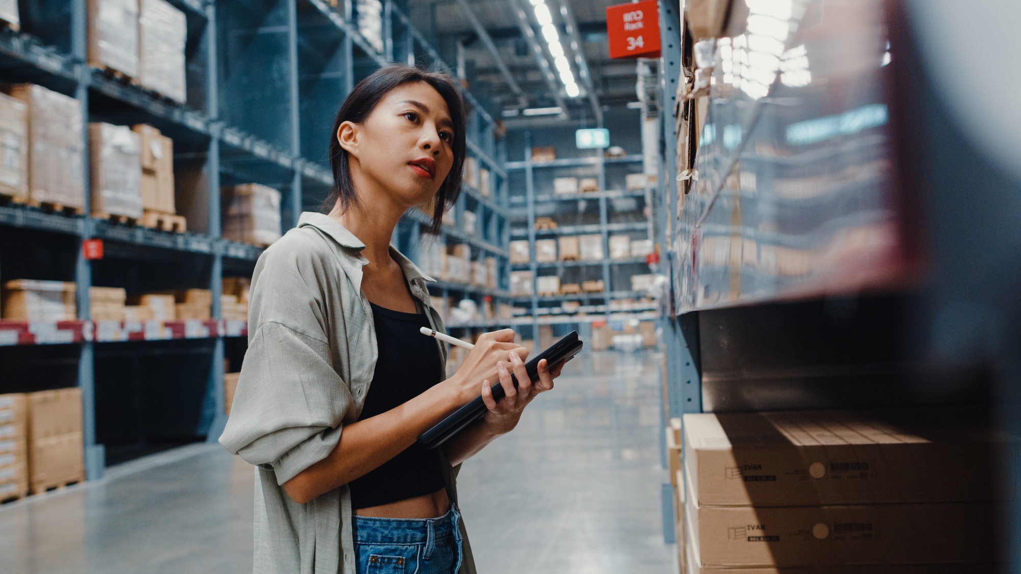 woman manager looking for goods using digital tablet checking inventory.