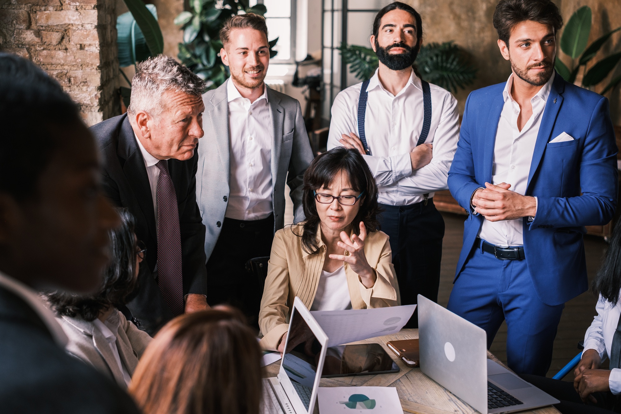 Woman responsible for the company surrounded by managers to direct the strategy to follow