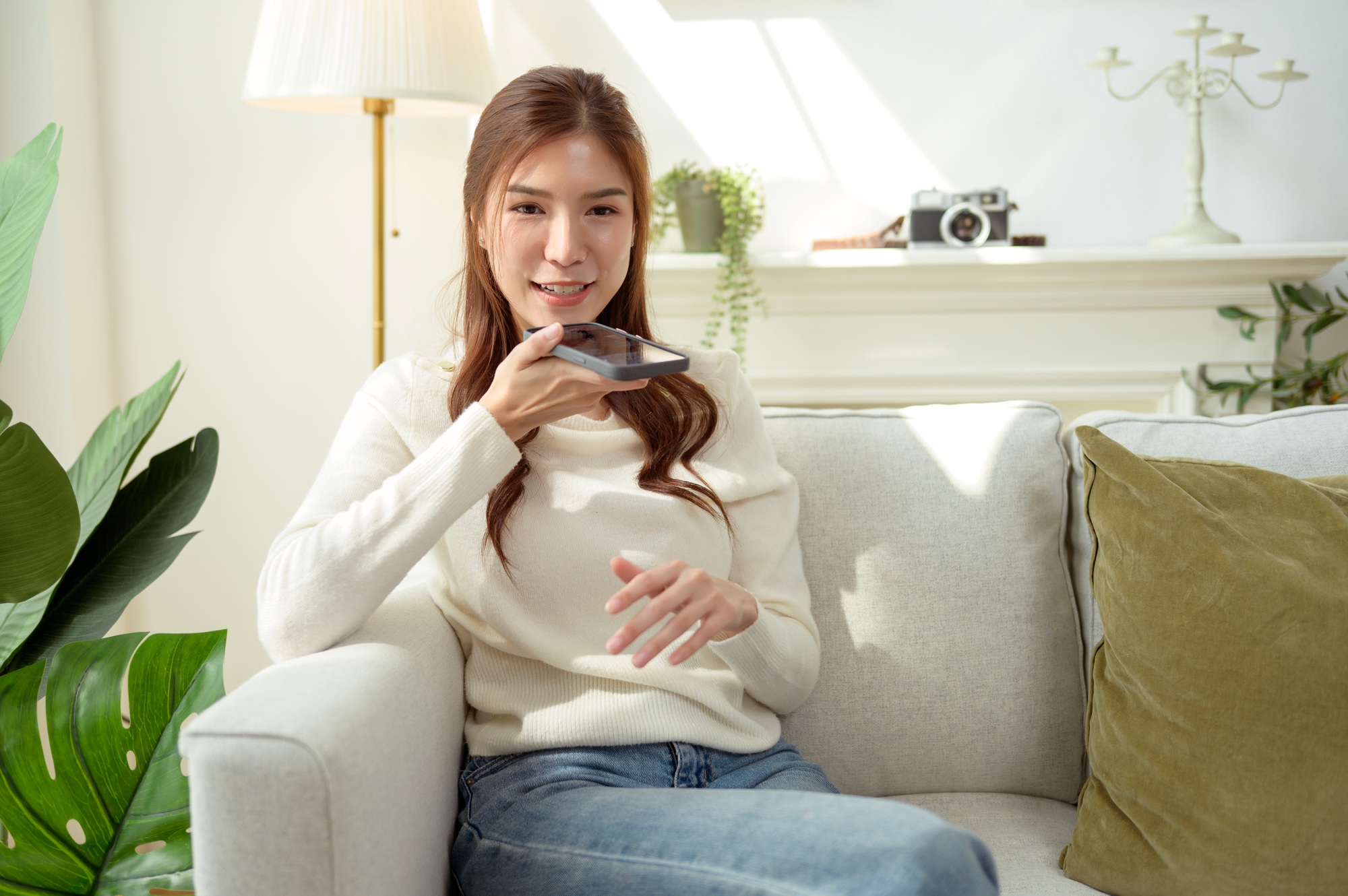 woman talking with AI via smartphone at home