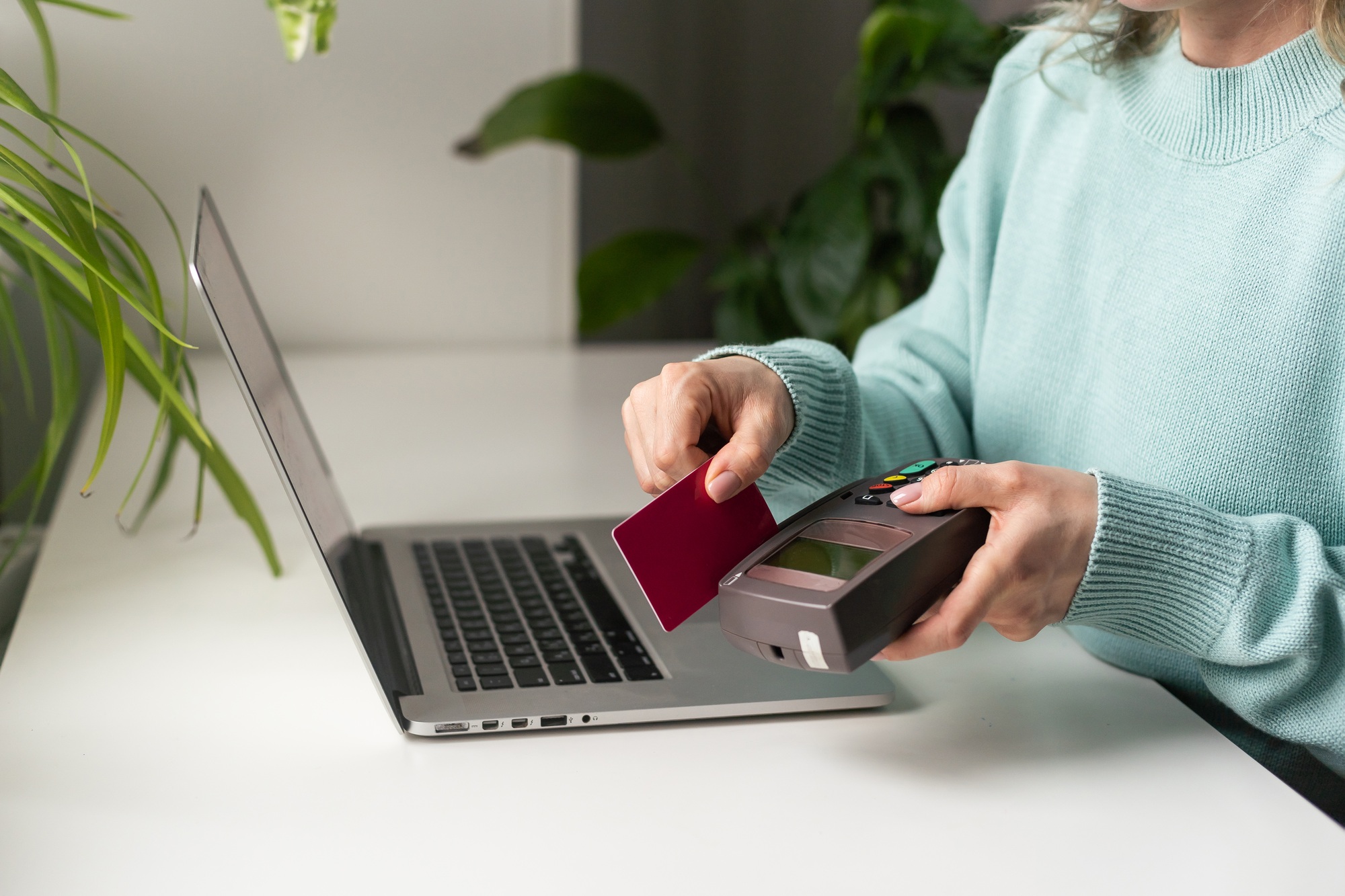 woman using payment card terminal to shop online with credit card, pos terminal.