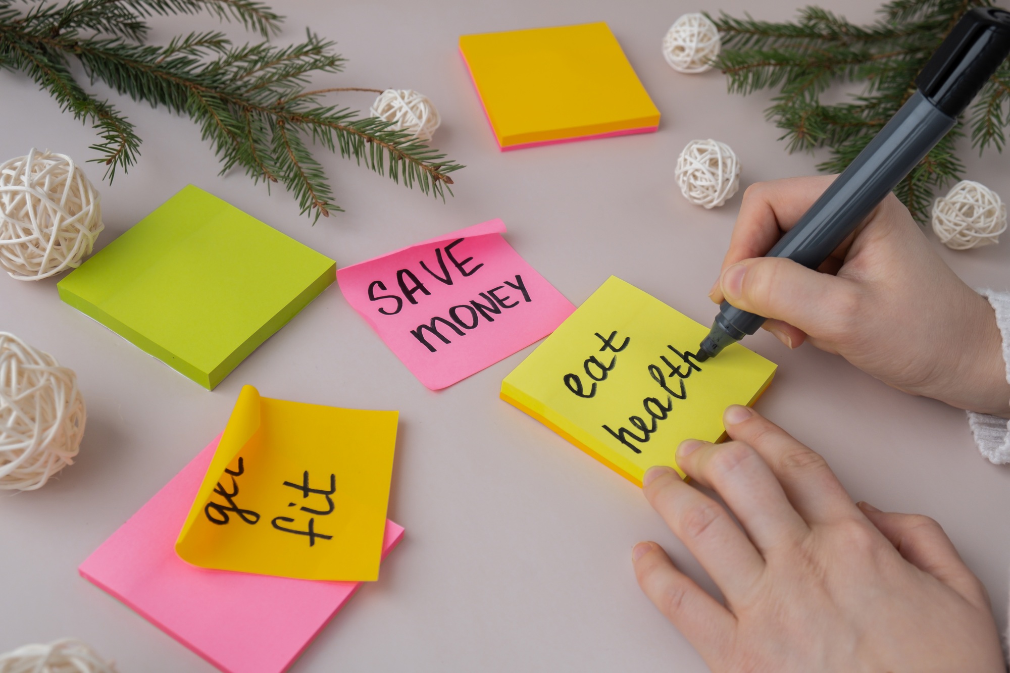 Woman writing promises and aims. Preparation for new year new life new me. Visualizing wish list for