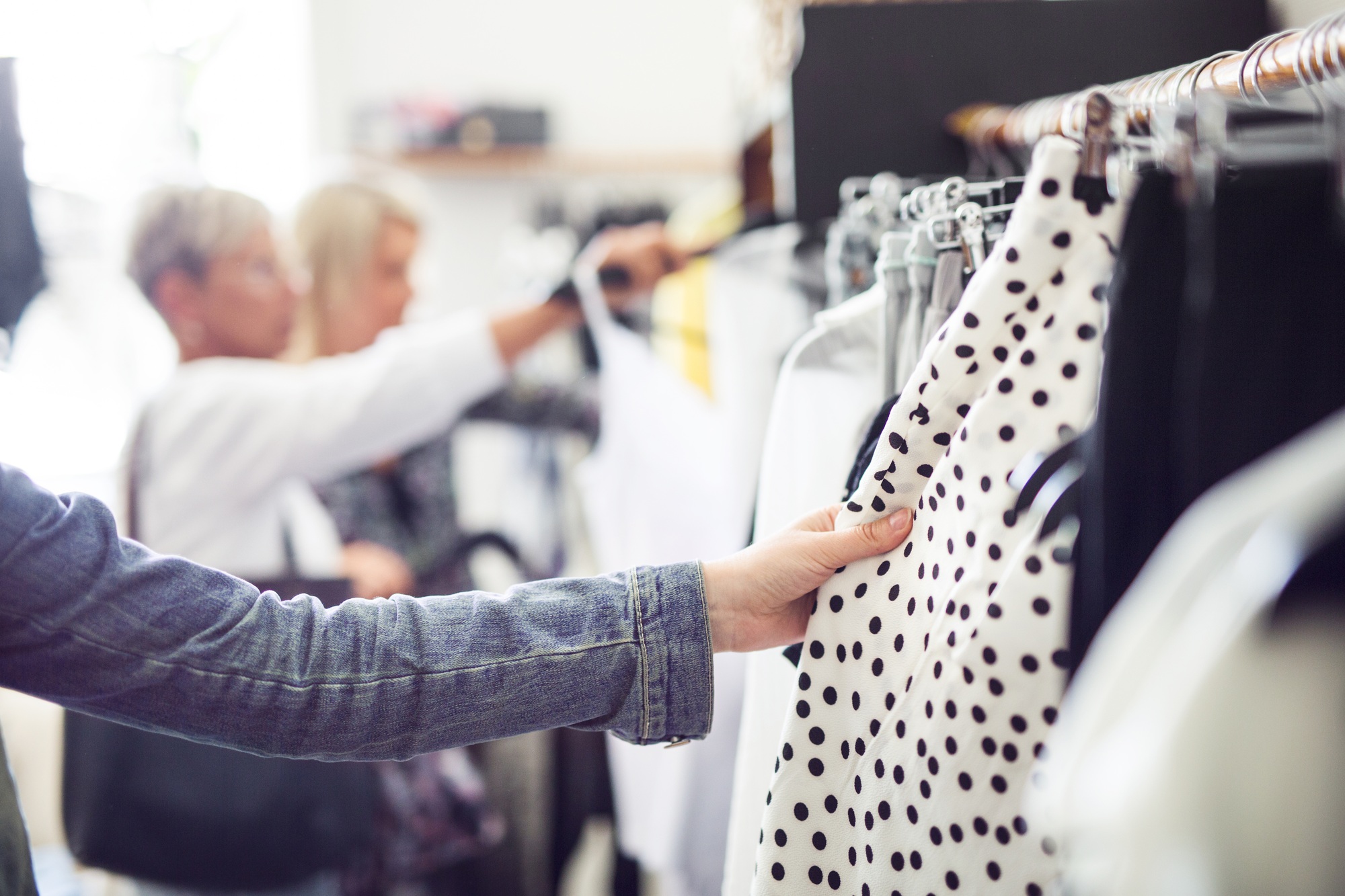 Women looking at clothes in shop