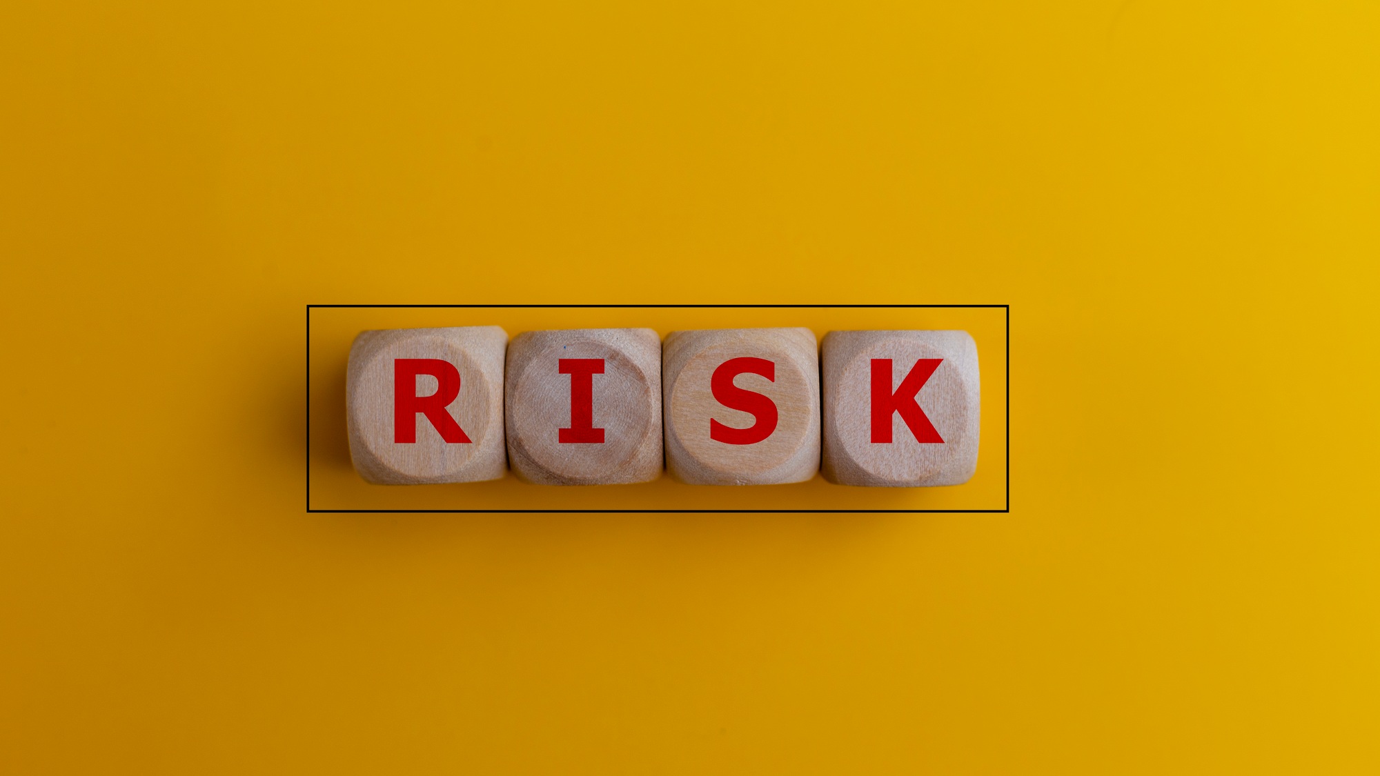 Wooden cubes with the word risk. Risk-taking, risk management, or assessment concept.