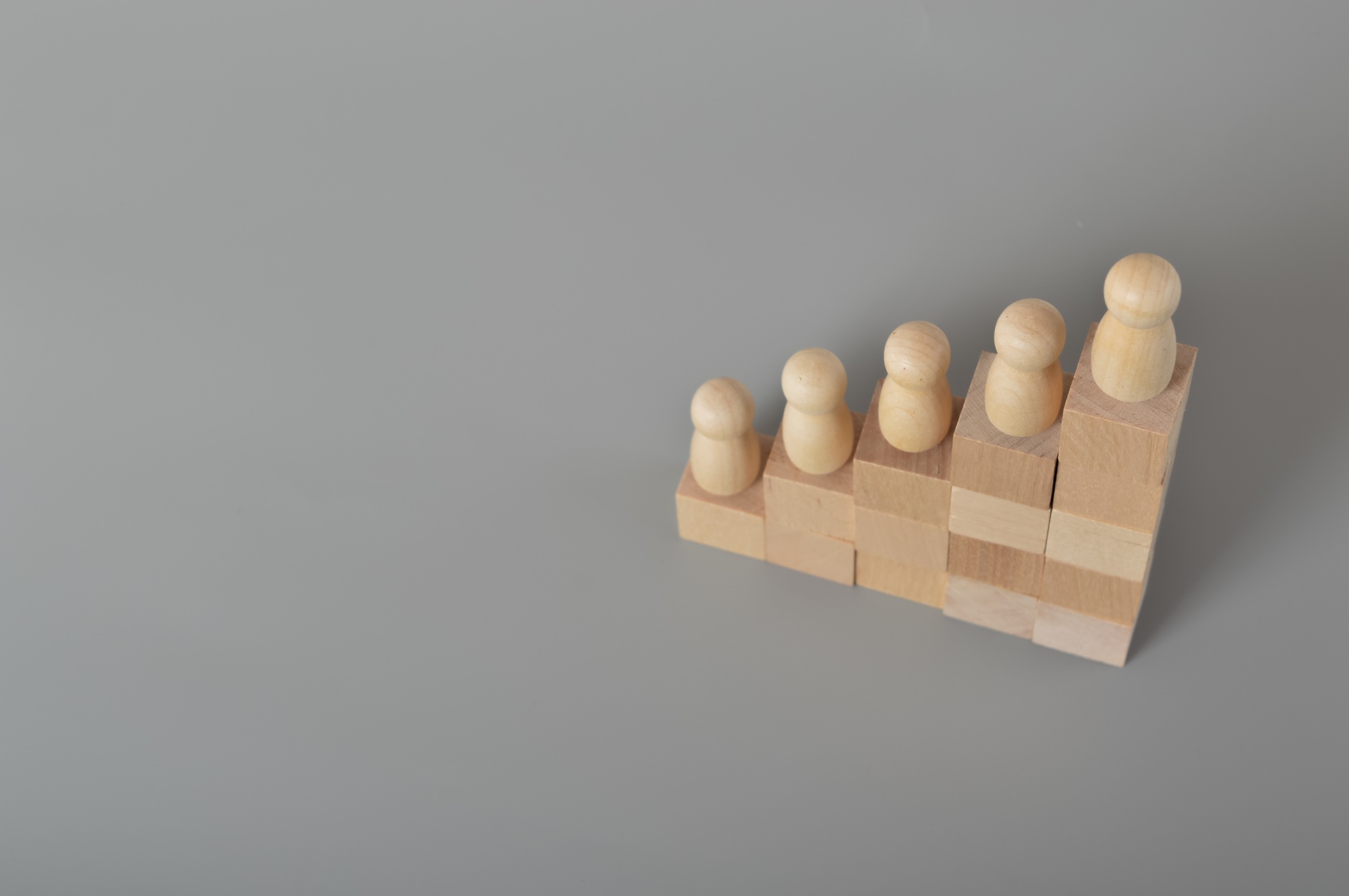 Wooden people of figures standing on wooden block Career growth, development, leadership,development