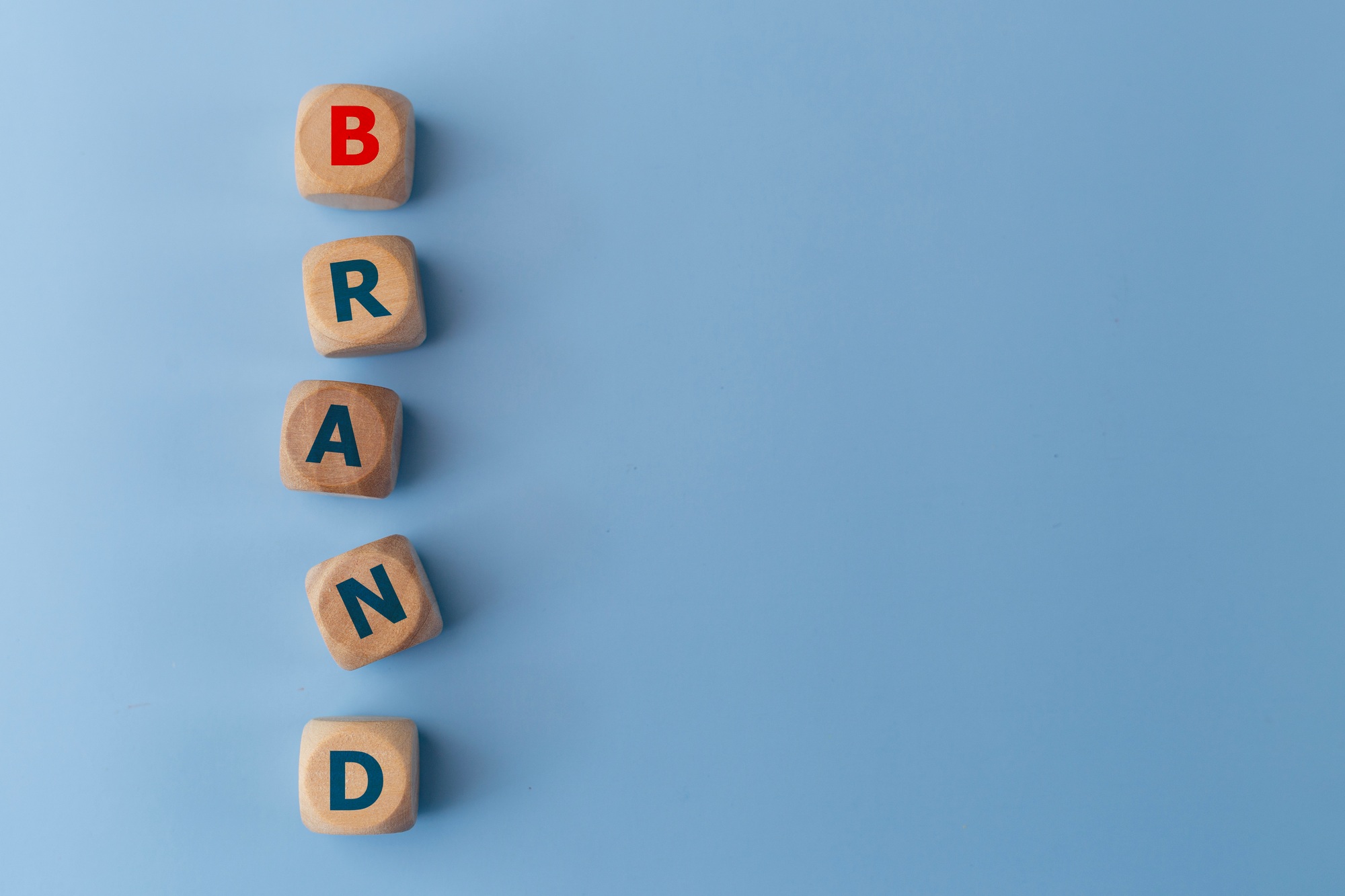 Word BAND on wooden cubes on a blue background. Business concept. Brand identity