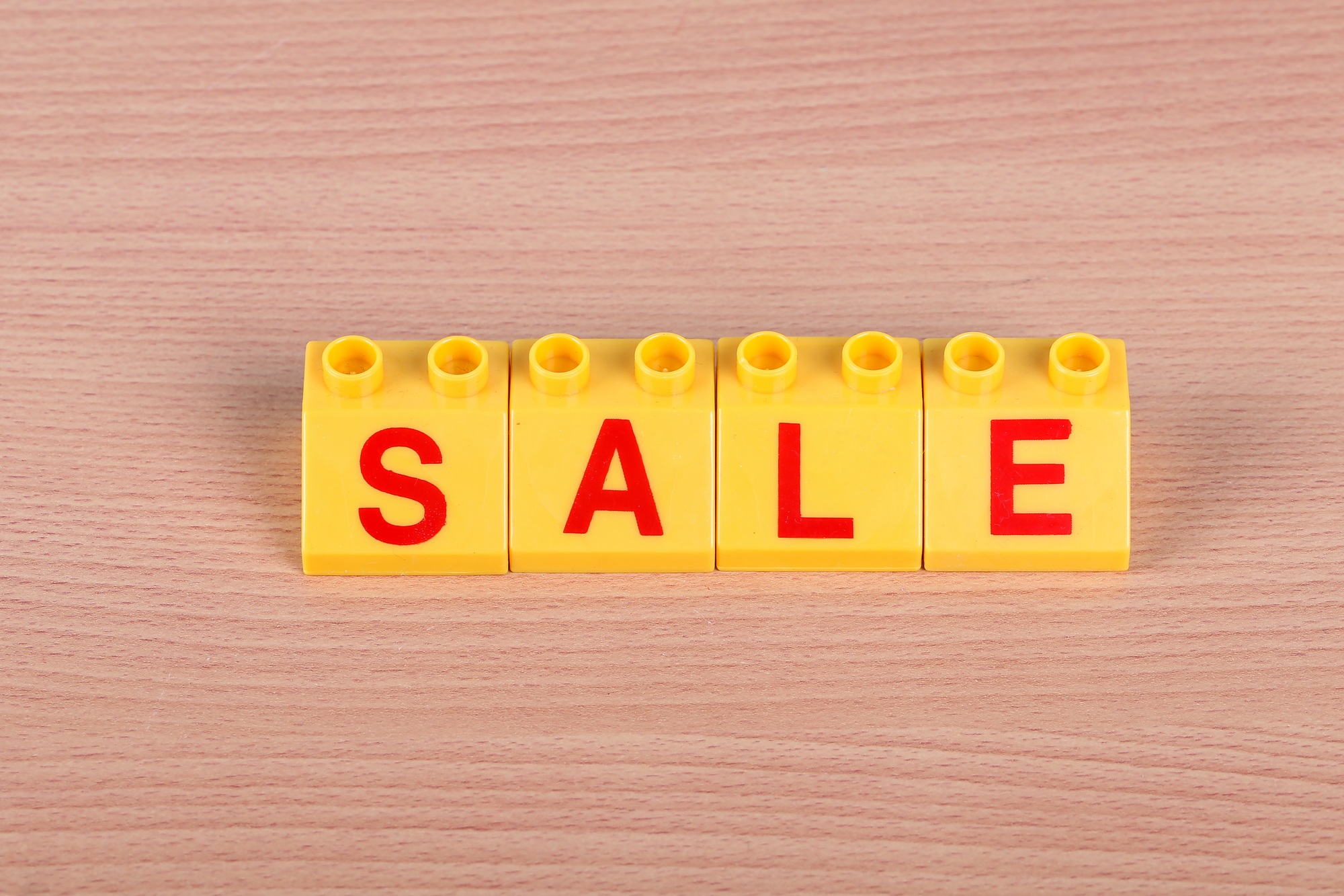 Word SALE set up on a wooden table