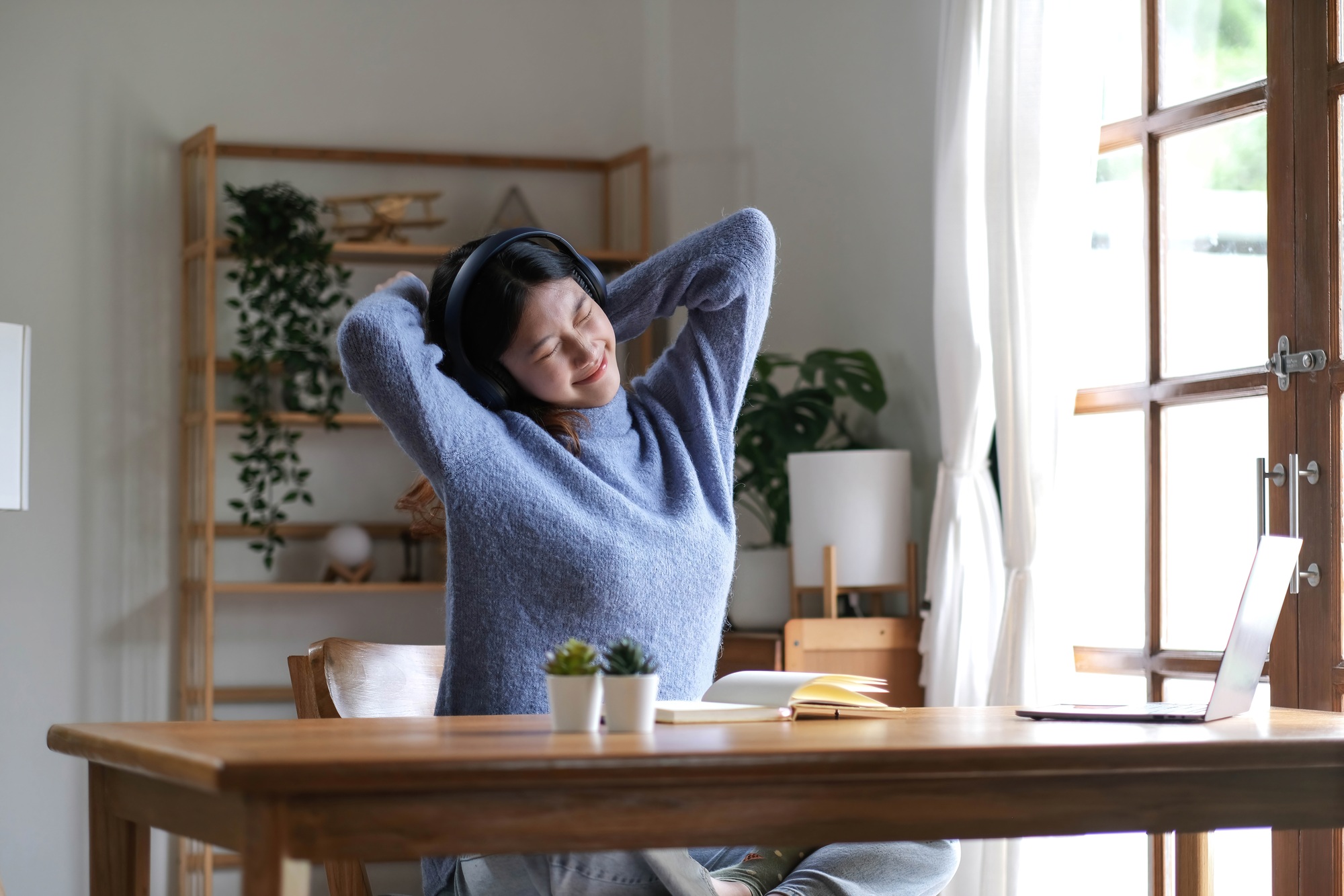 Young attractive asian female relax cross arm behind head use notebook digital online