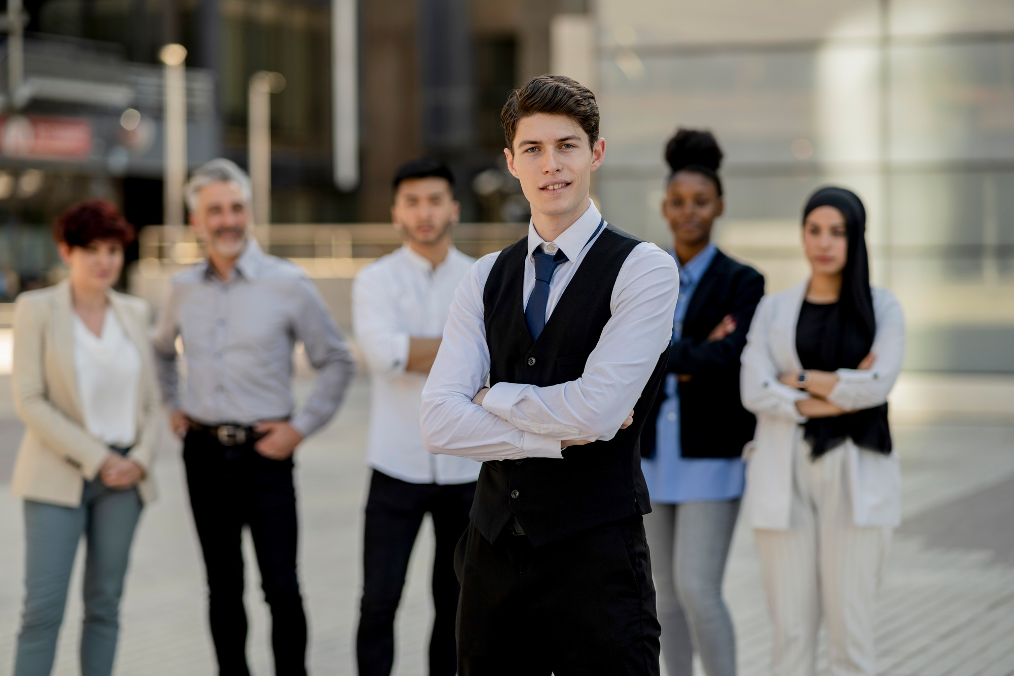 Young Business Leader with Diverse Team in Urban Setting