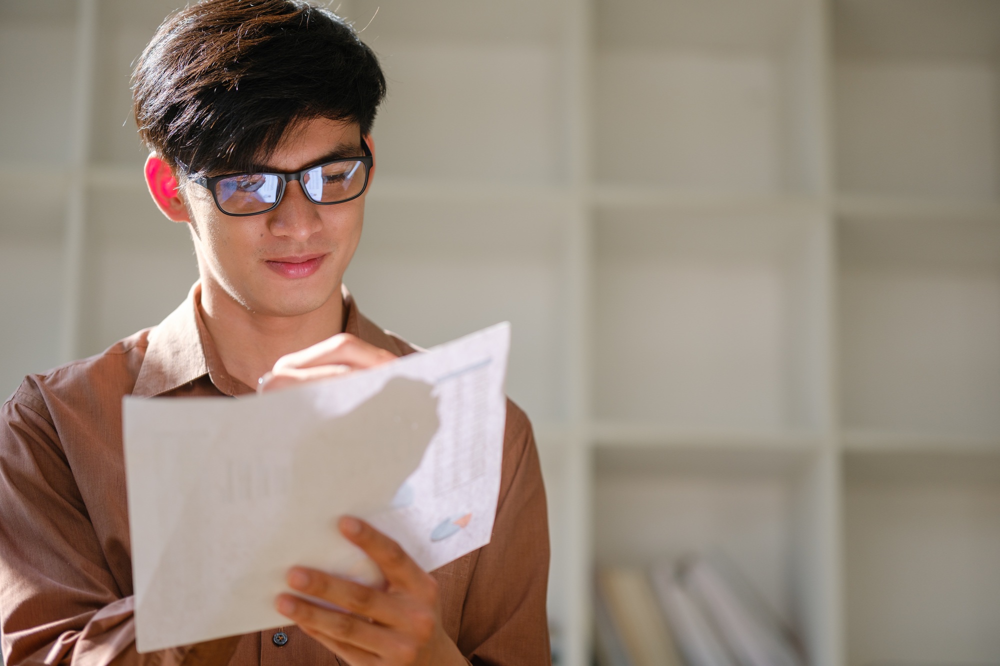 Young businessman analyzing financial data and market trends for investment decisions